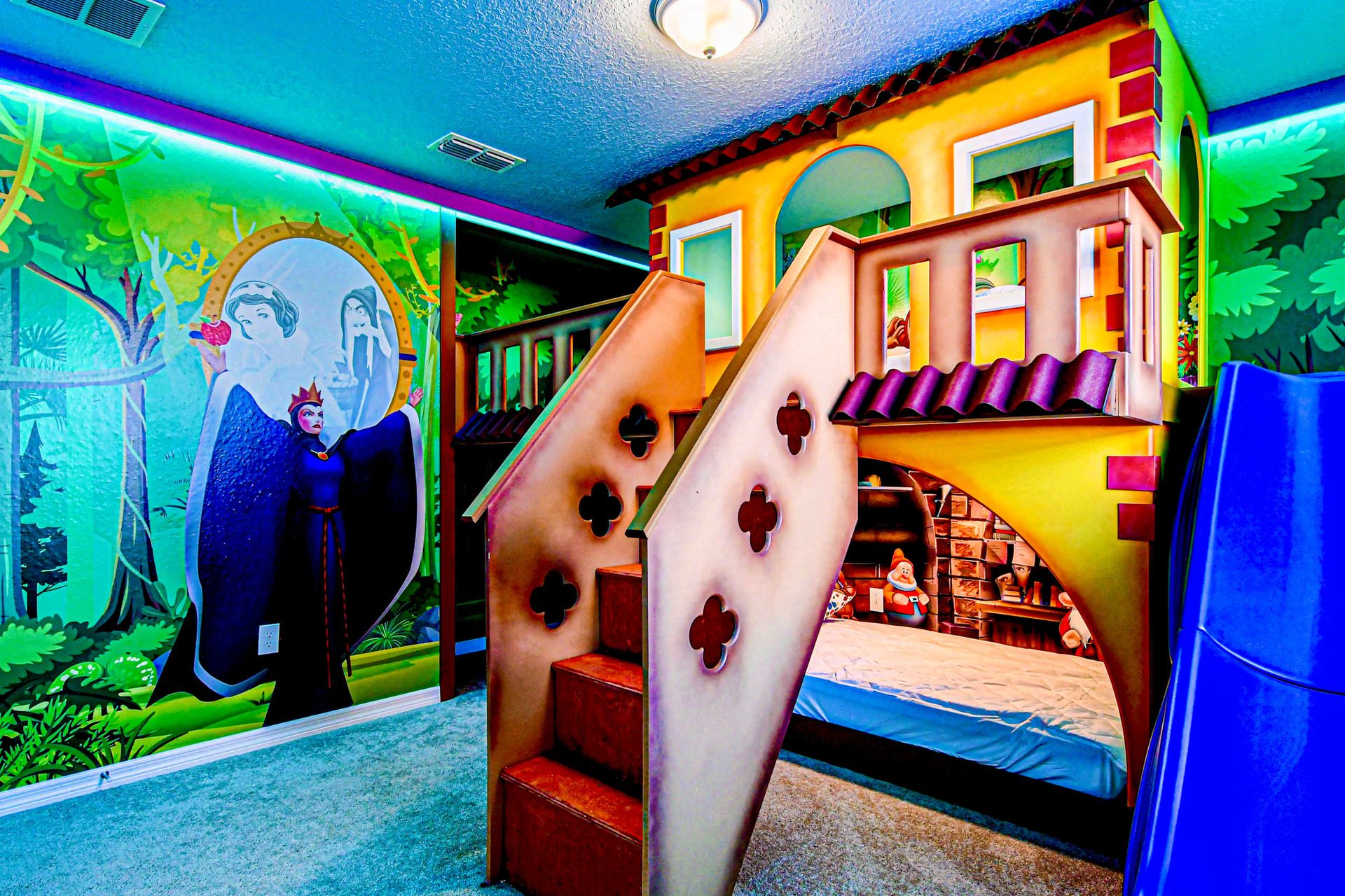 Enchanted forest bunk room with castle playhouse, slide, and villainous mural!
