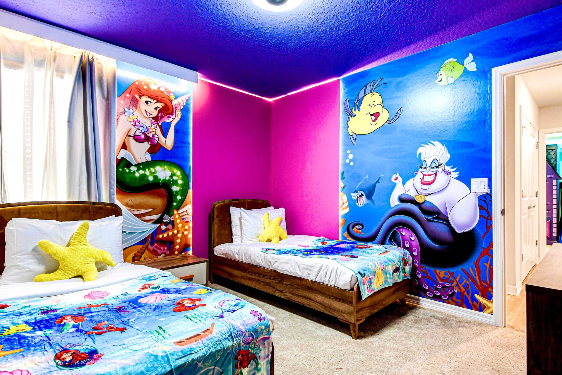 Magical mermaid room with twin beds, ocean murals, and vibrant underwater charm!
