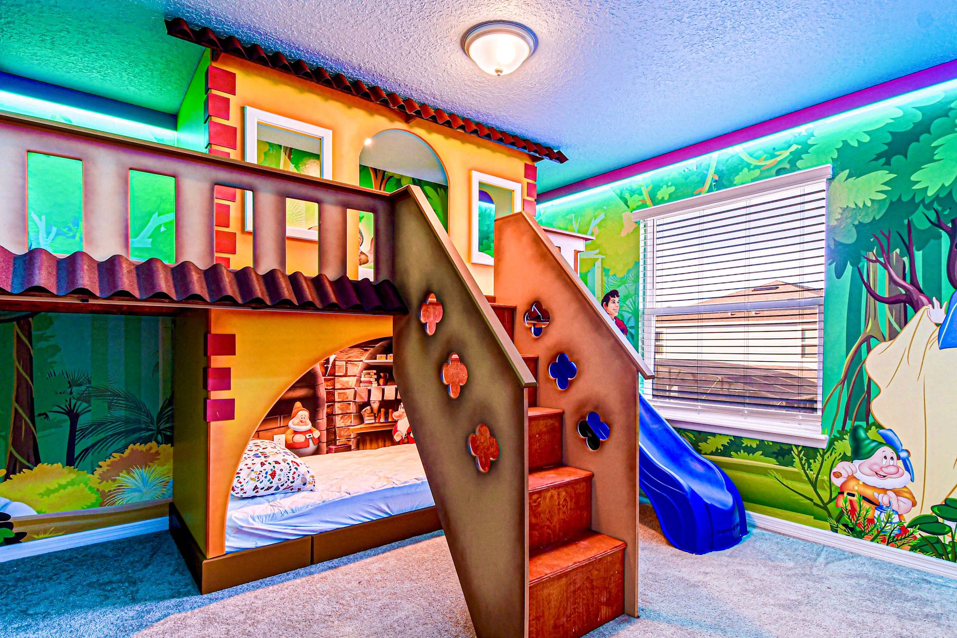 Fairy tale-themed kids' room with castle bunk, slide, and Snow White mural!
