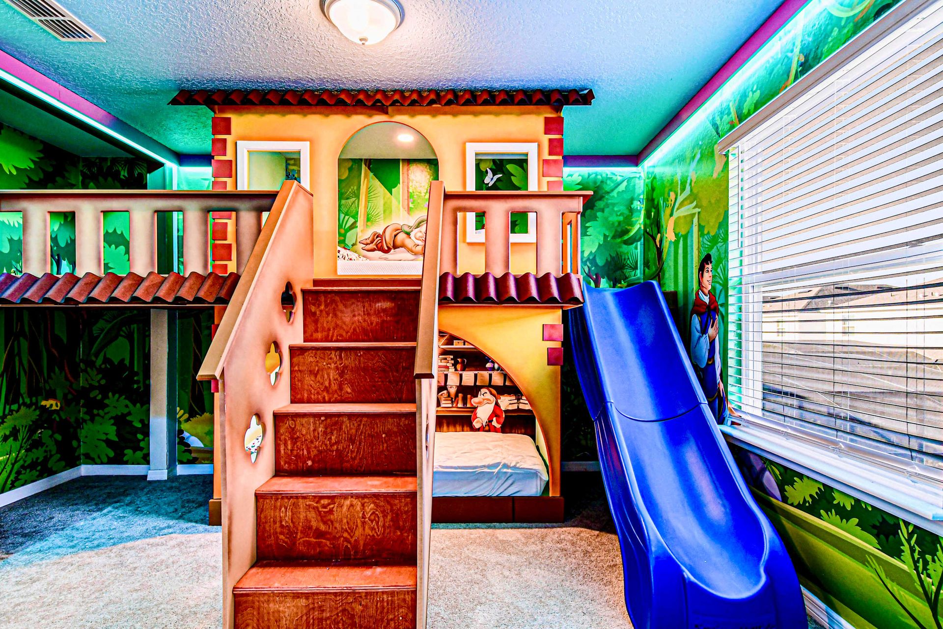 Jungle-themed kids' room with loft playhouse, slide, and cozy bunk beds!

