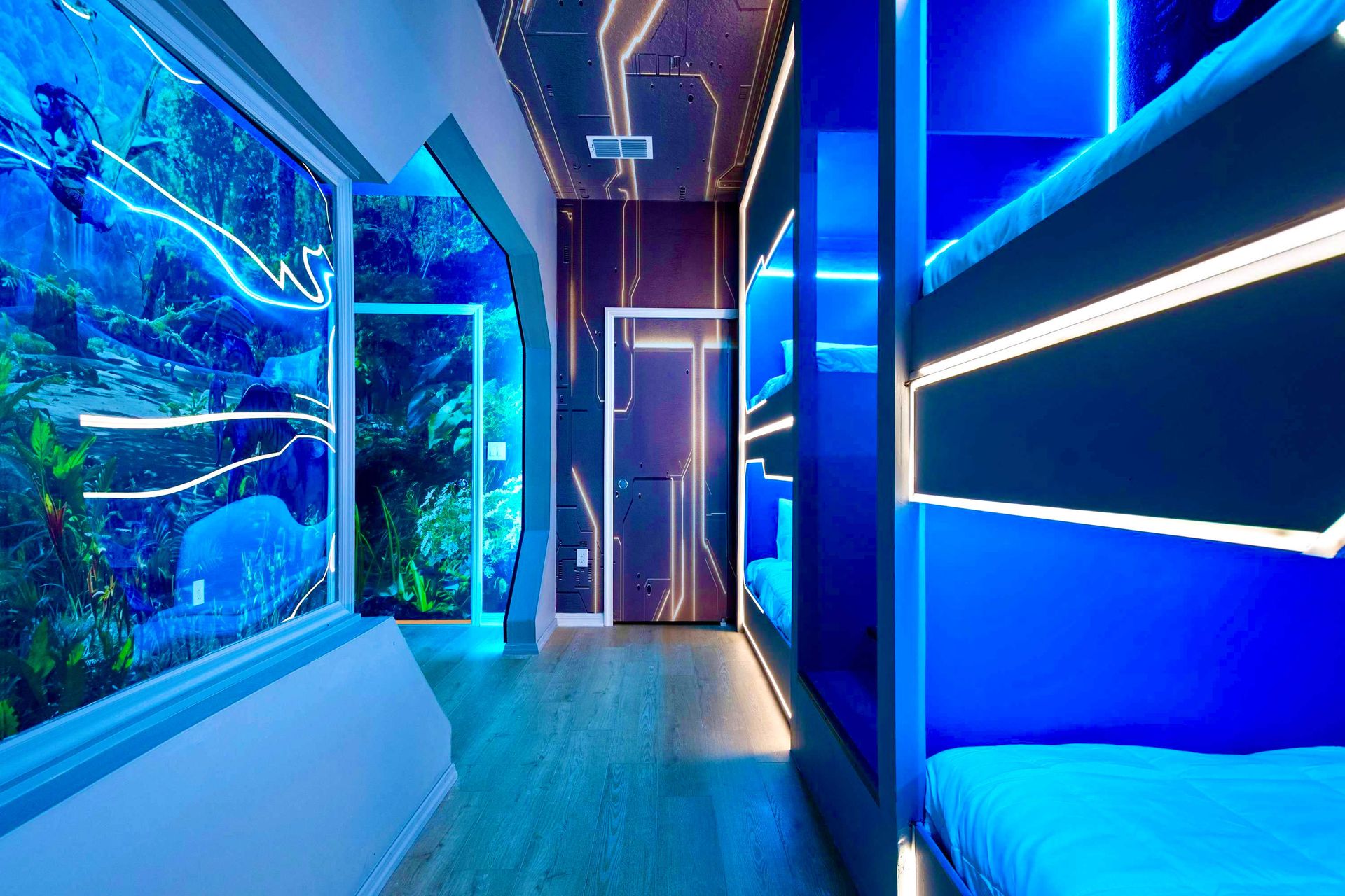 Immersive sci-fi bunk room with glowing blue lights and futuristic jungle visuals
