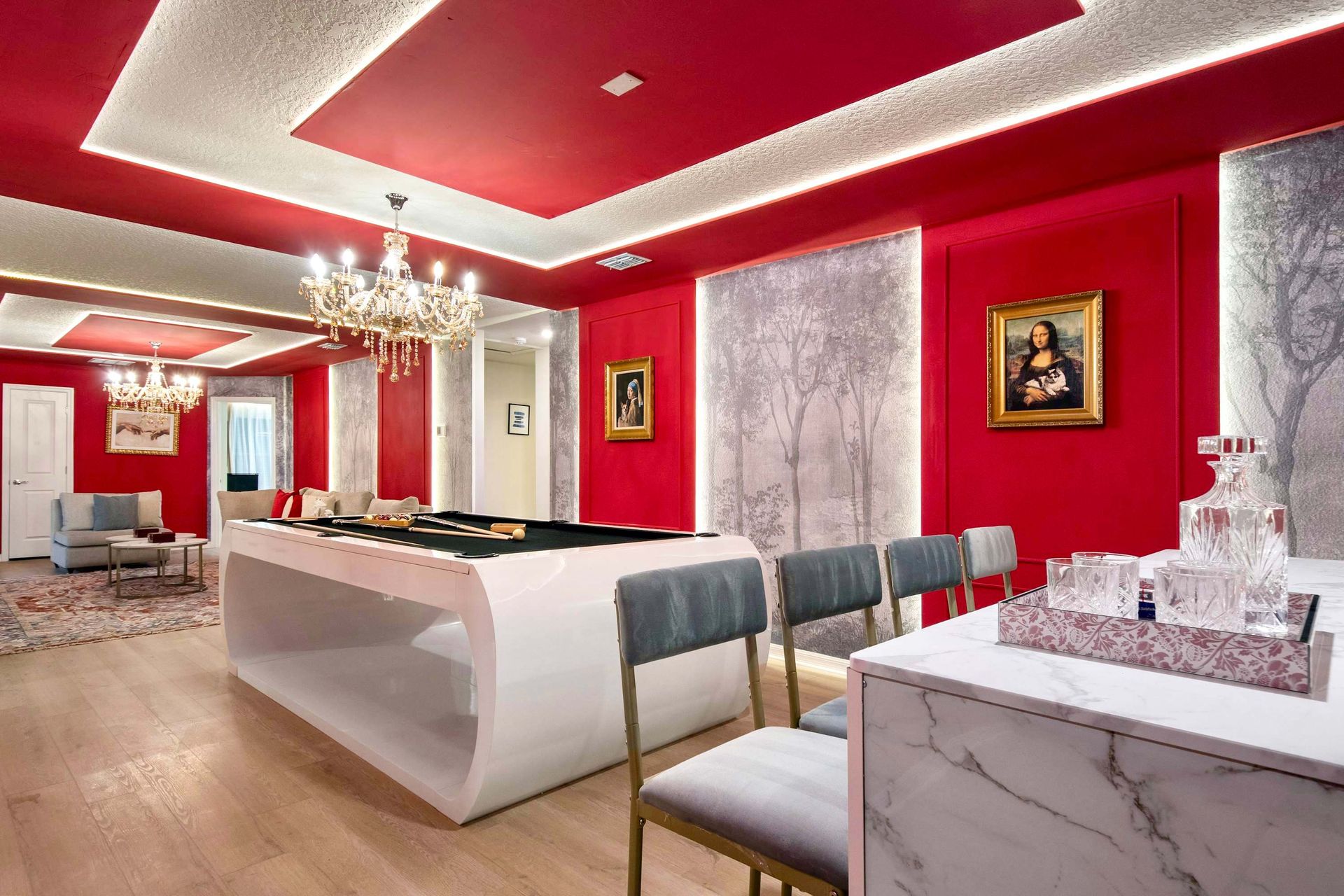 Chic red lounge with bold decor, crystal chandeliers, and modern marble bar
