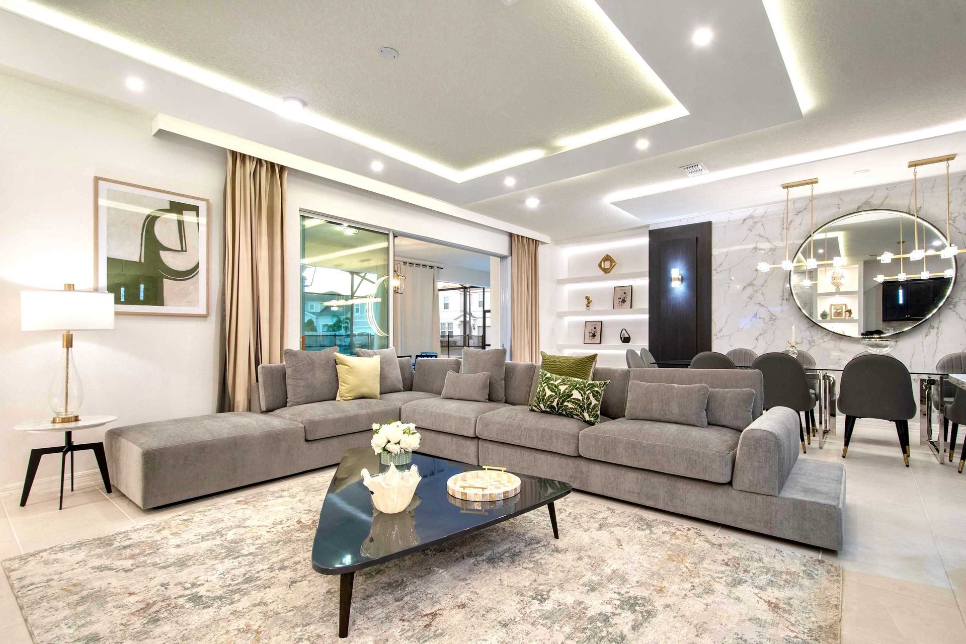 Spacious modern living room with sleek sectional, stylish décor, and open layout
