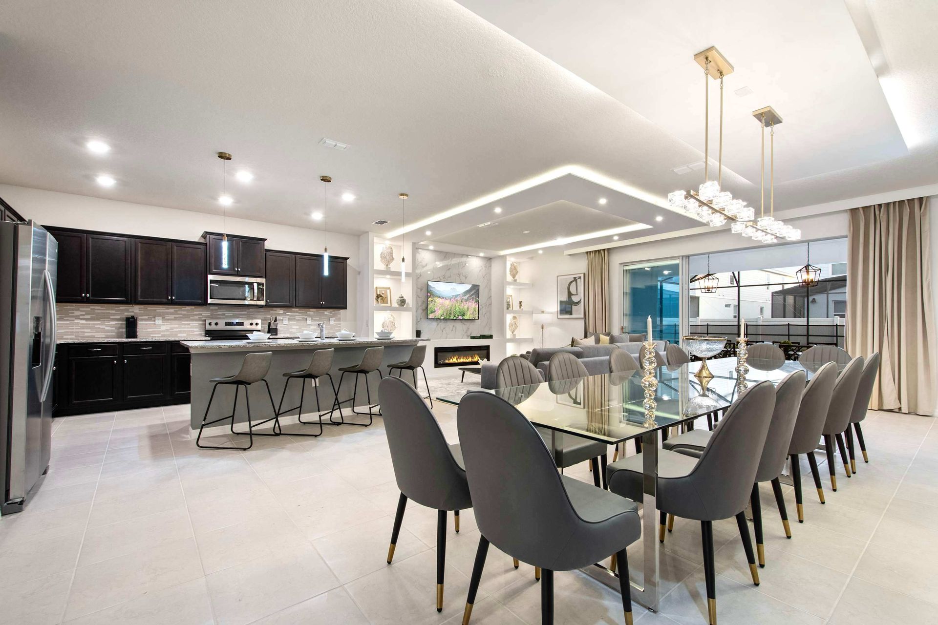 Stylish open-concept kitchen and dining area with sleek finishes and modern lighting
