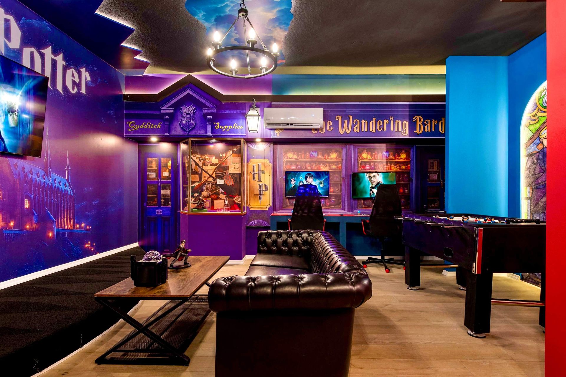 Wizard-themed game room with cozy seating, foosball, and magical decor throughout
