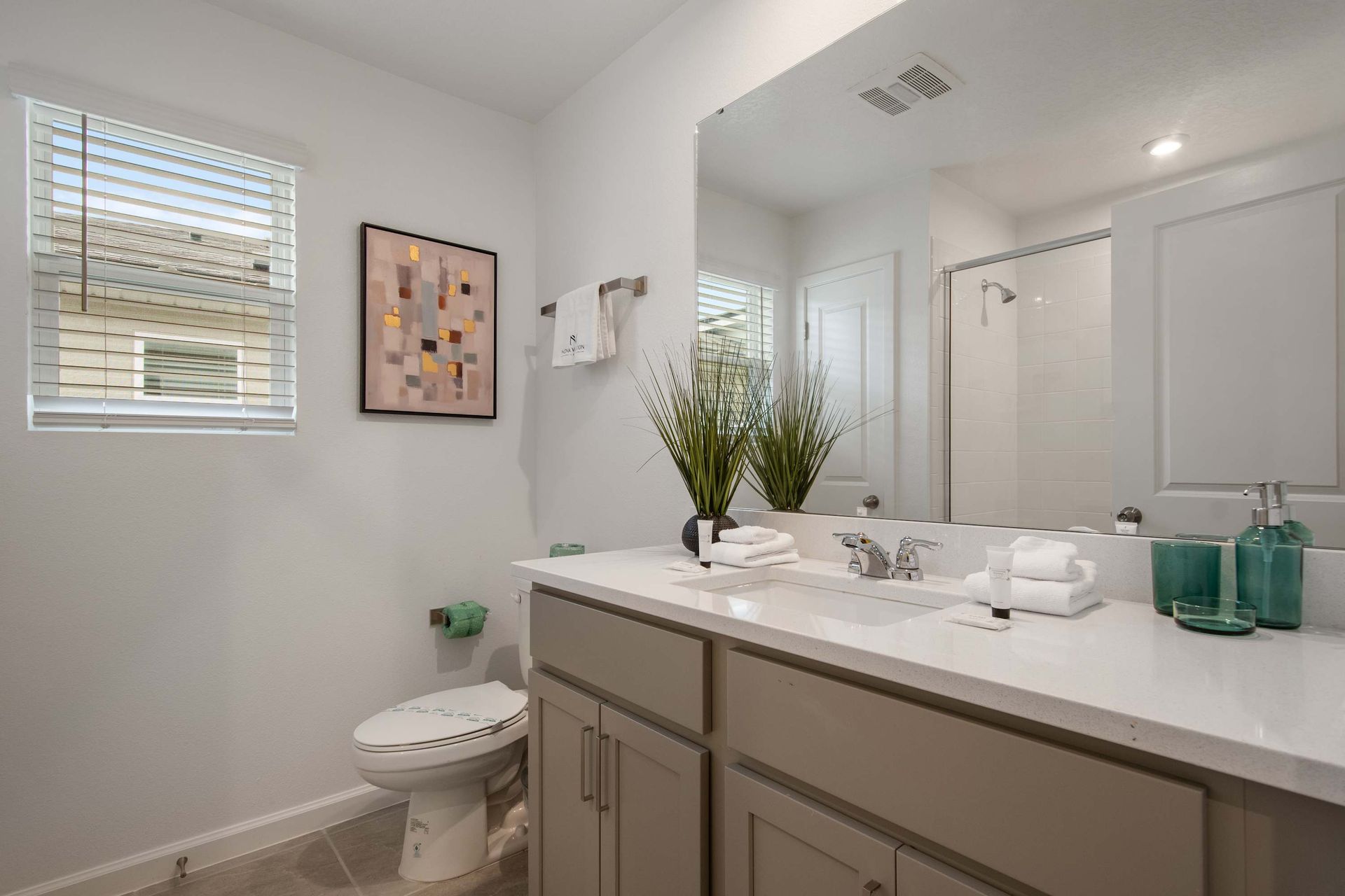 Bright Modern Bathroom with Walk-In Shower, Large Mirror & Natural Light
