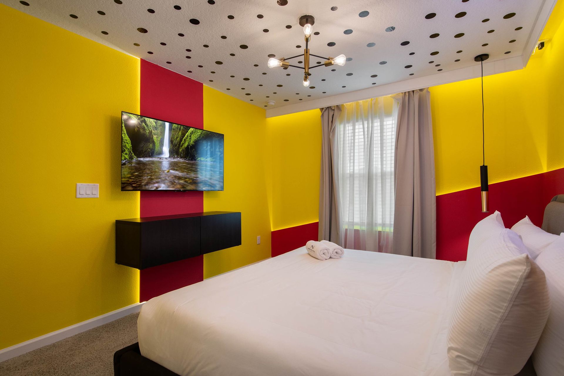 Bright and Cheerful King Bedroom with Polka Dot Ceiling, Bold Walls & Smart TV
