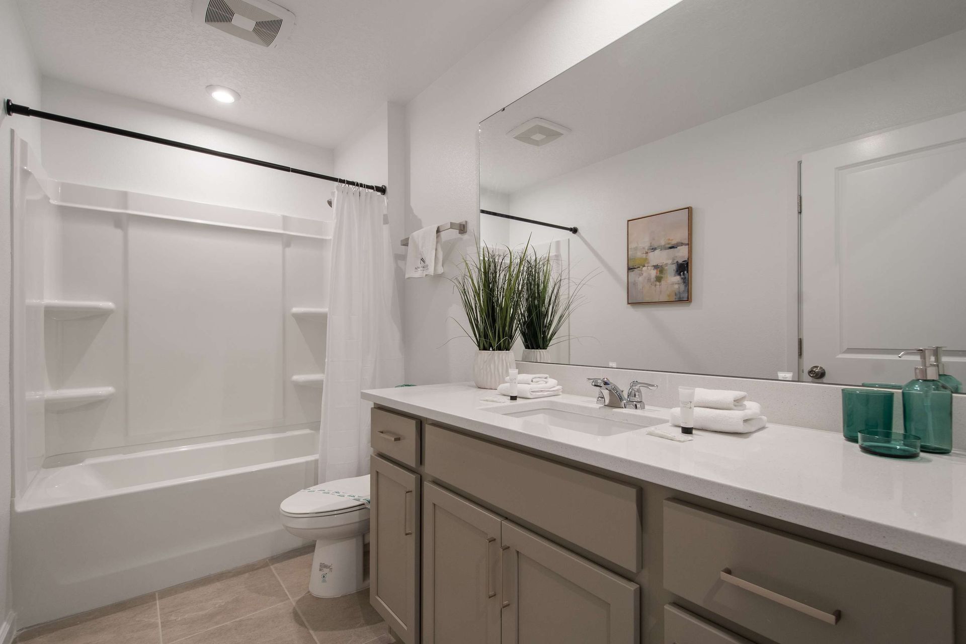 Clean and Modern Bathroom with Tub/Shower Combo, Double Vanity & Bright Lighting
