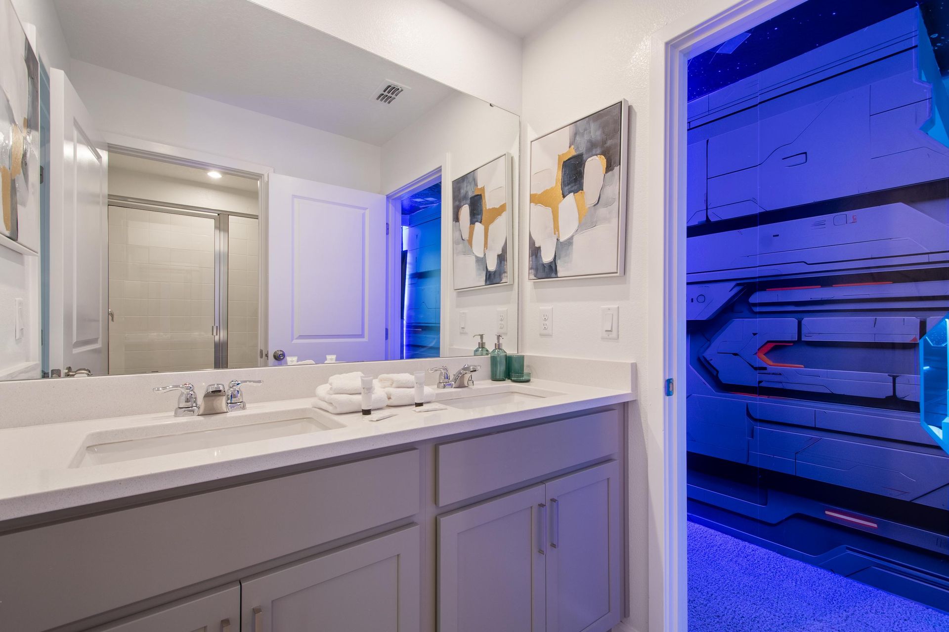 Modern Bathroom with Double Vanity, Walk-In Shower & Access to Themed Bedroom
