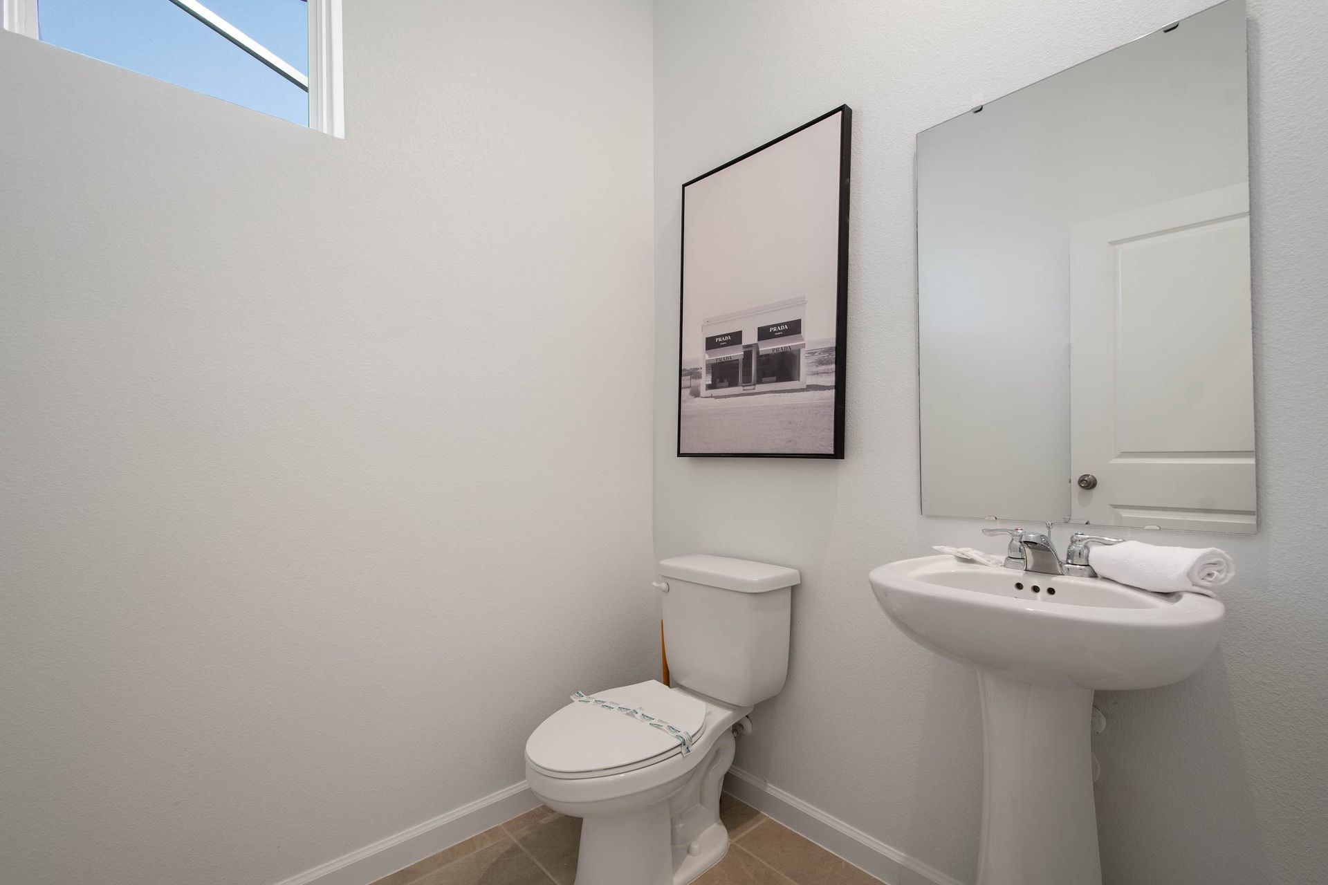 Simple and Clean Half Bath with Pedestal Sink, Modern Fixtures & Natural Light
