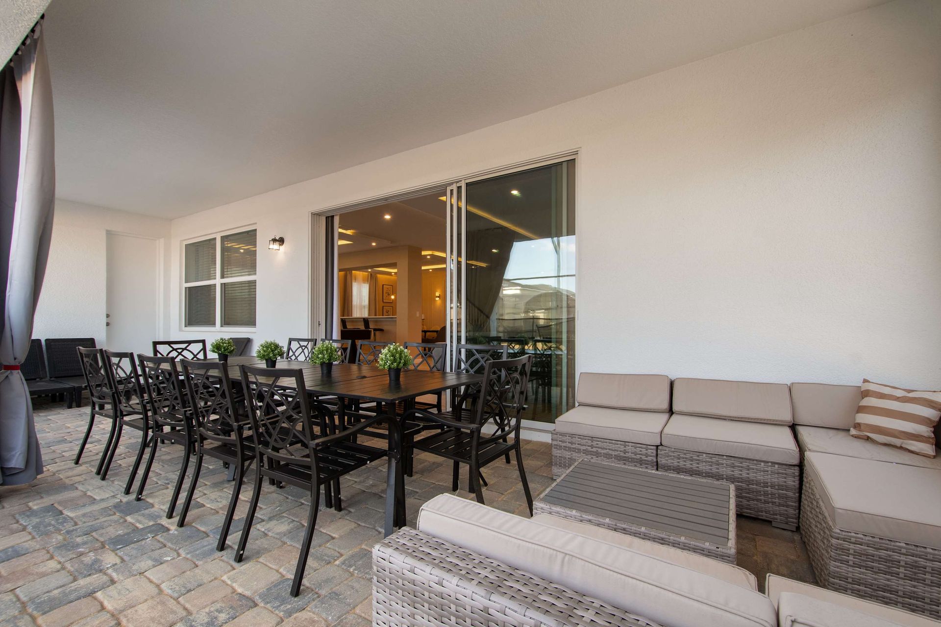 Spacious Covered Patio with Dining for 12 and Cozy Outdoor Lounge Seating
