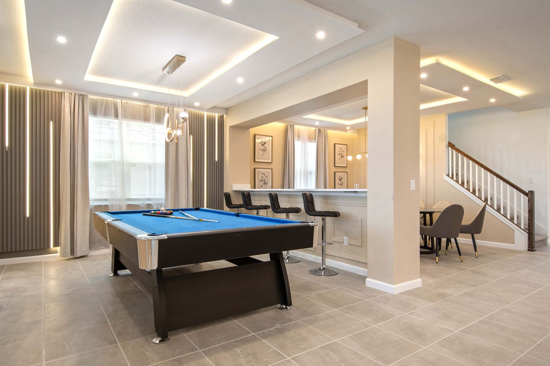 Stylish Game Room with Pool Table, Bar Seating, and Modern Lounge Vibes
