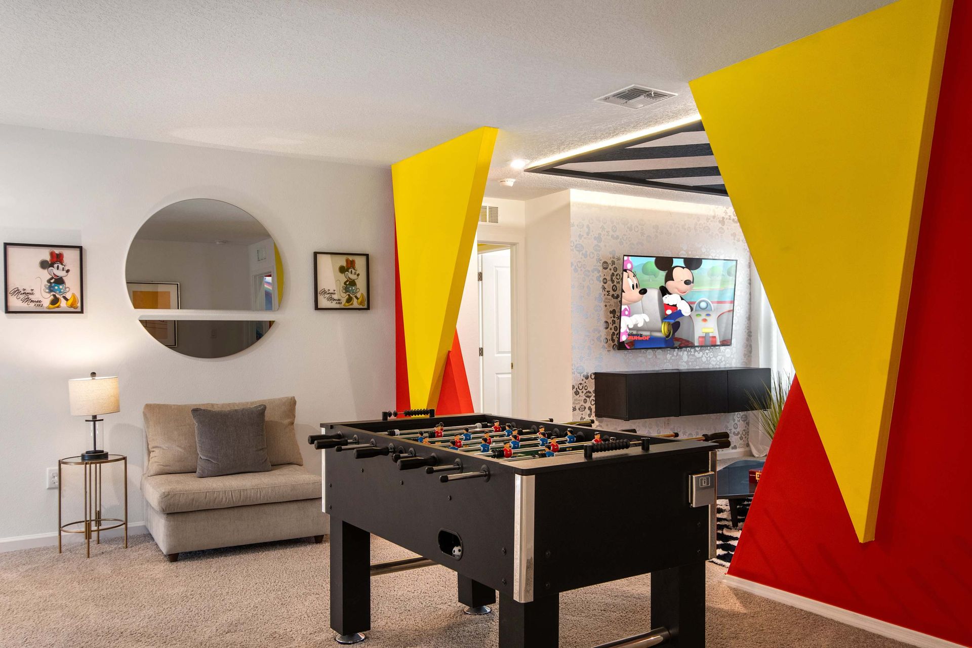 Colorful Mickey-Themed Game Loft with Foosball, TV Lounge & Playful Decor

