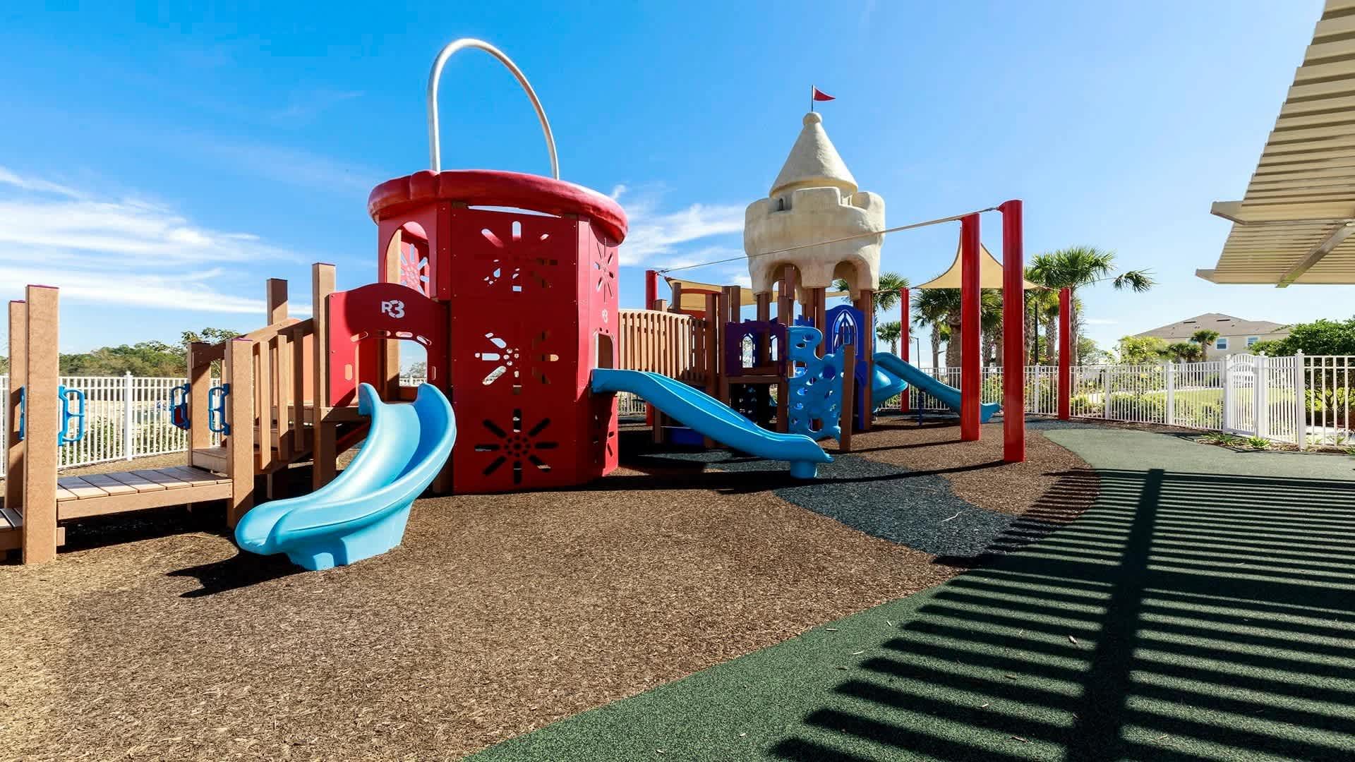 Whimsical castle playground with slides and shade—perfect for little adventurers