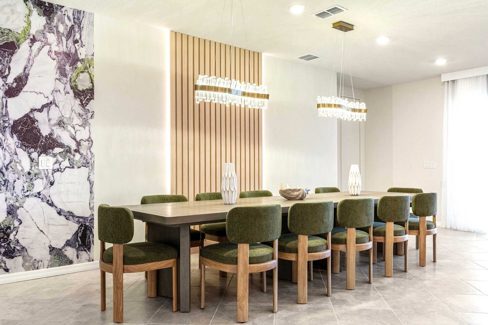 Elegant dining room with seating for twelve, modern lighting, and stylish decor