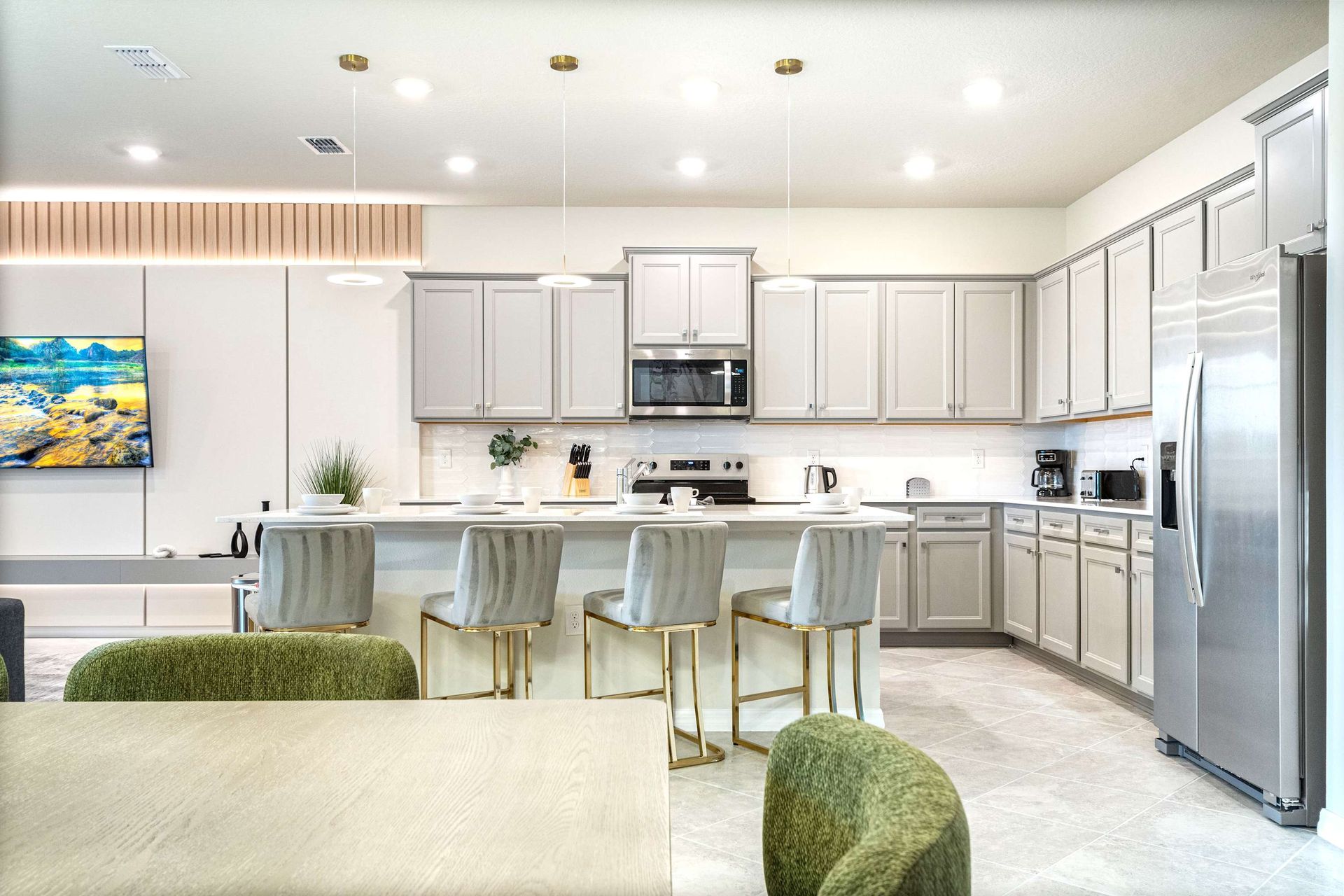Gourmet kitchen with sleek appliances, spacious island, and stylish seating
