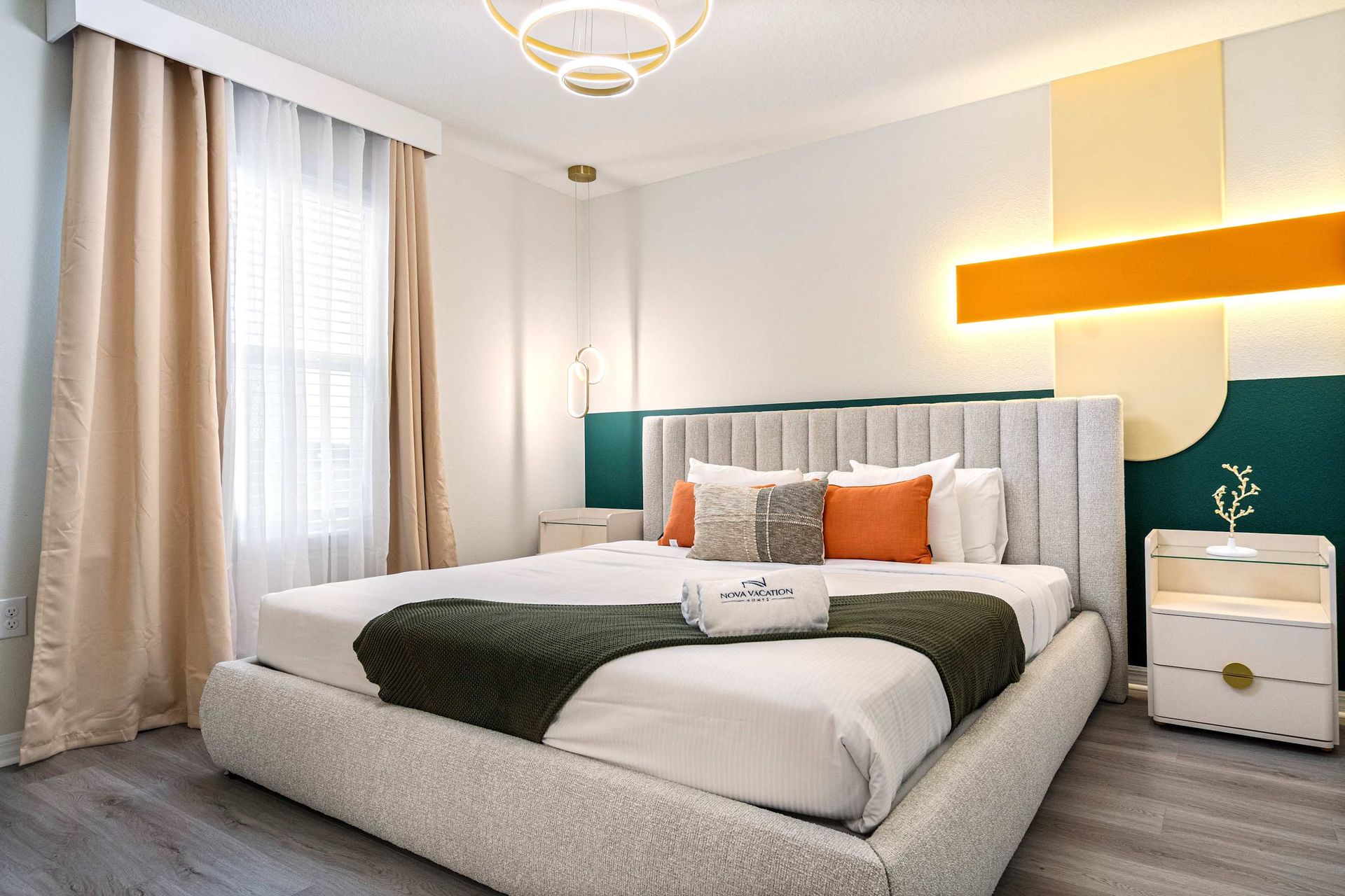 Stylish modern room with bold design, cozy bed, and vibrant accent lighting.