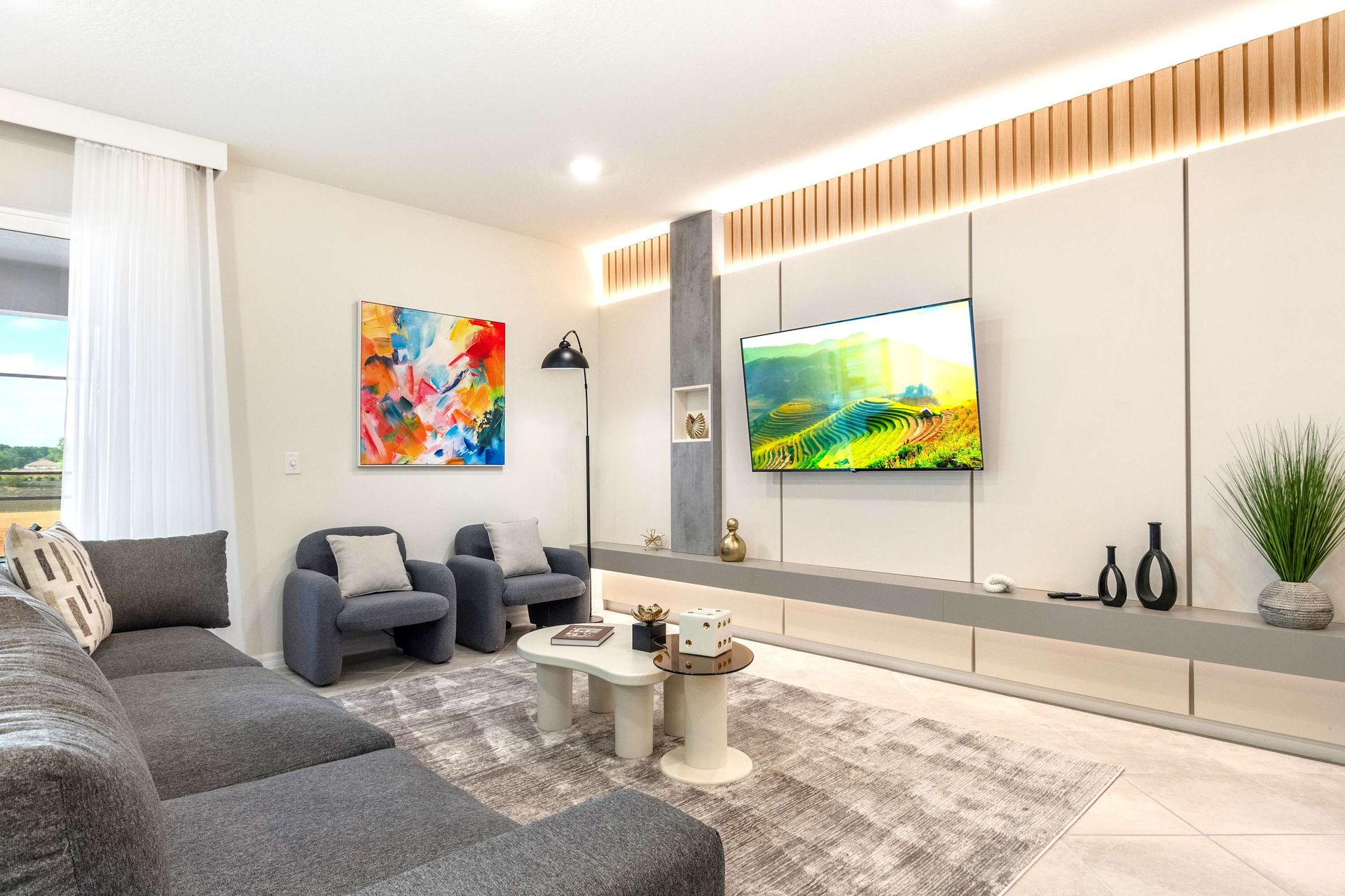 Chic modern living room with smart TV, cozy seating, and designer finishes