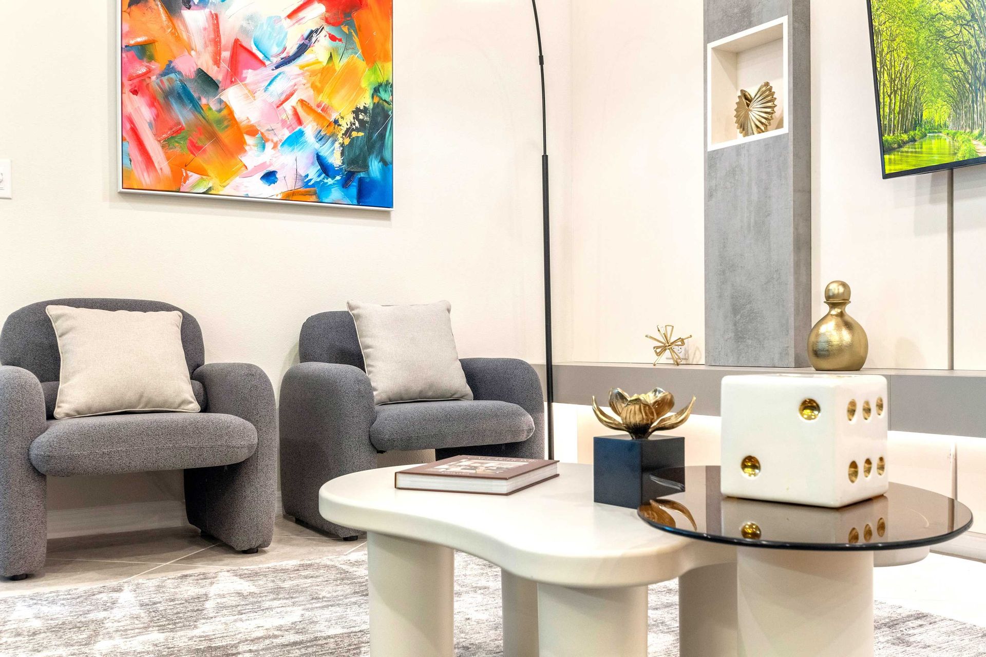 Contemporary lounge with cozy chairs, bold art, and elegant modern decor touches