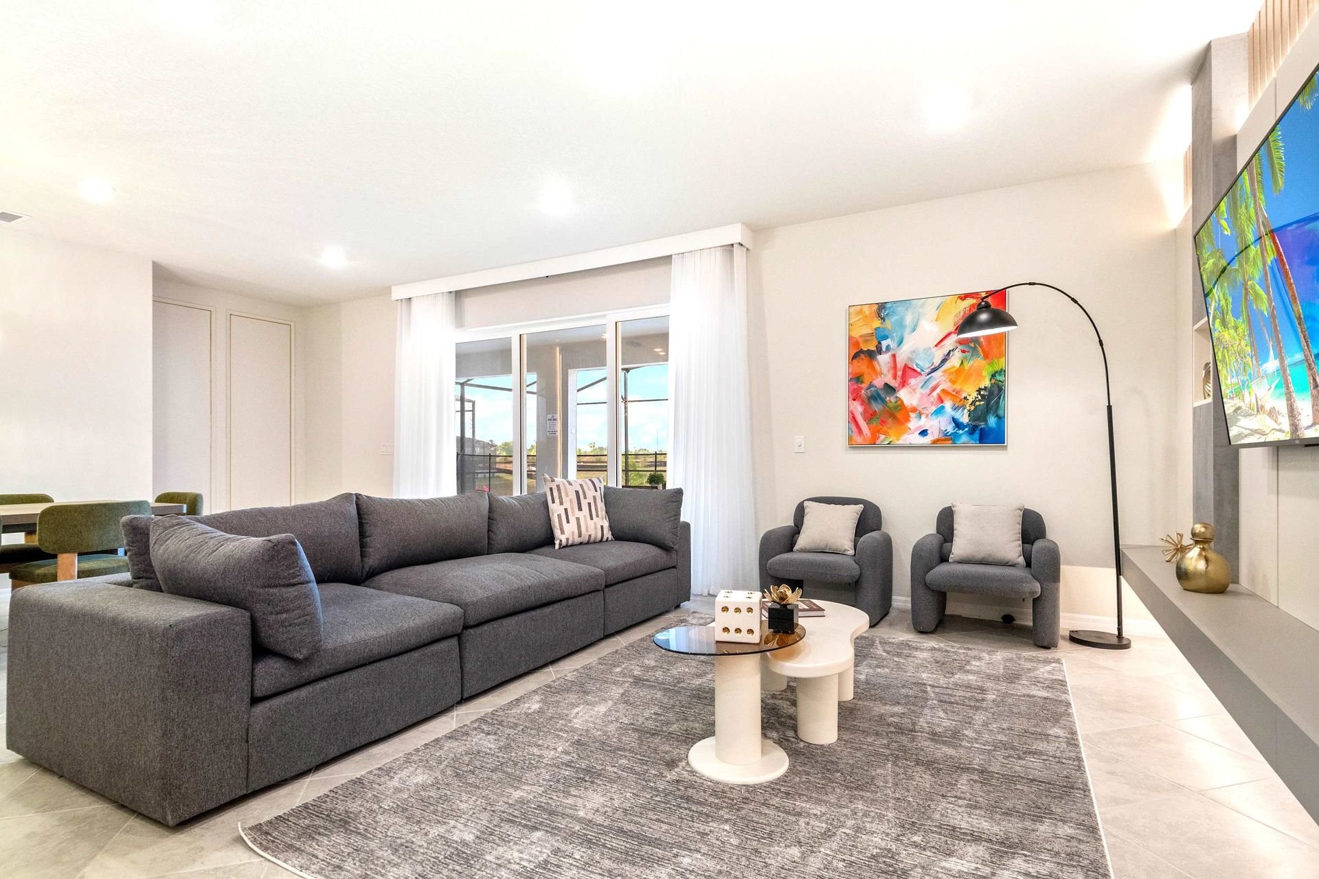 Spacious modern living room with plush sectional, bold art, and natural light