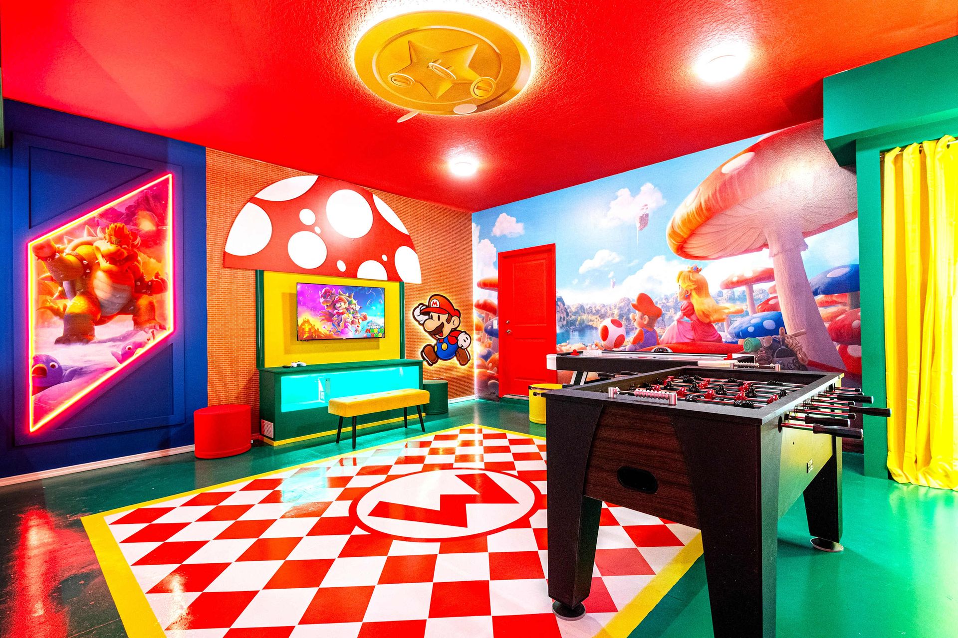 Super Mario-themed game room with foosball, TV, and vibrant immersive decor