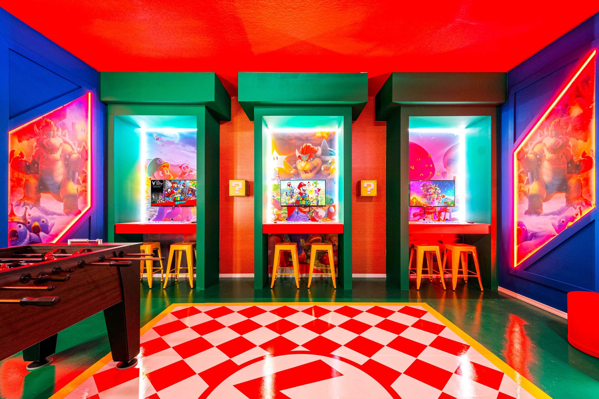 Colorful Super Mario game room with foosball, air hockey, and themed wall art