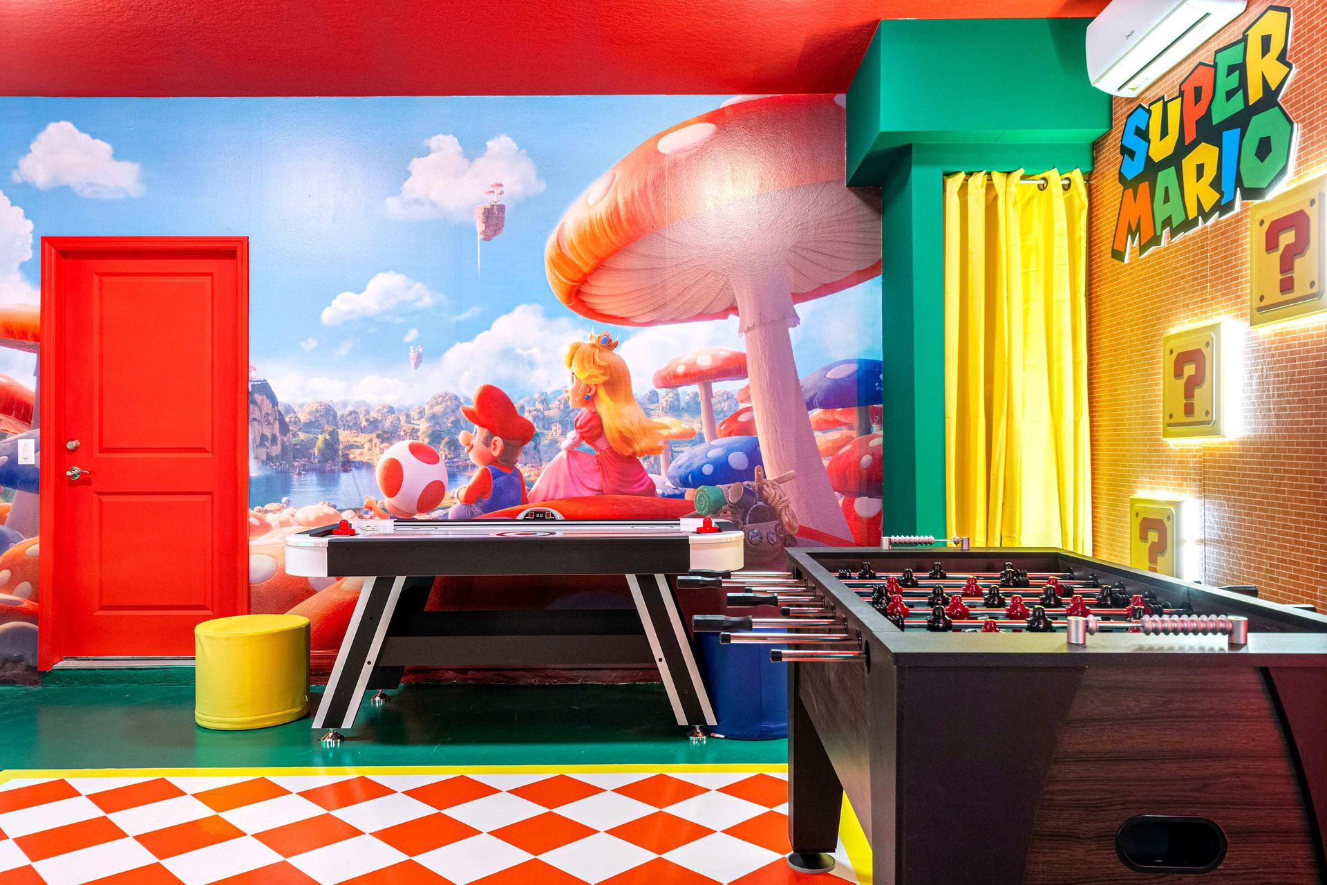 Colorful Super Mario game room with foosball, air hockey, and themed wall art