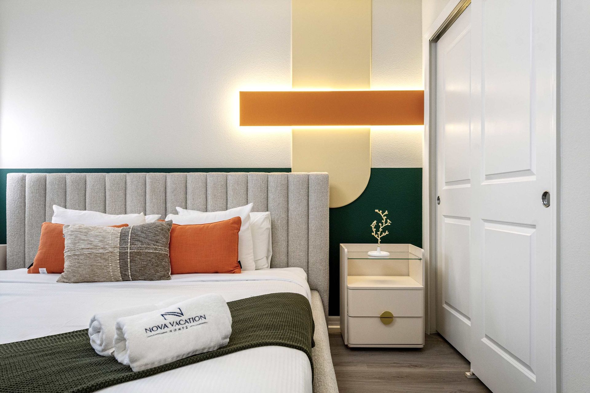 Chic and cozy retreat with modern lighting, plush bedding, and clean design.