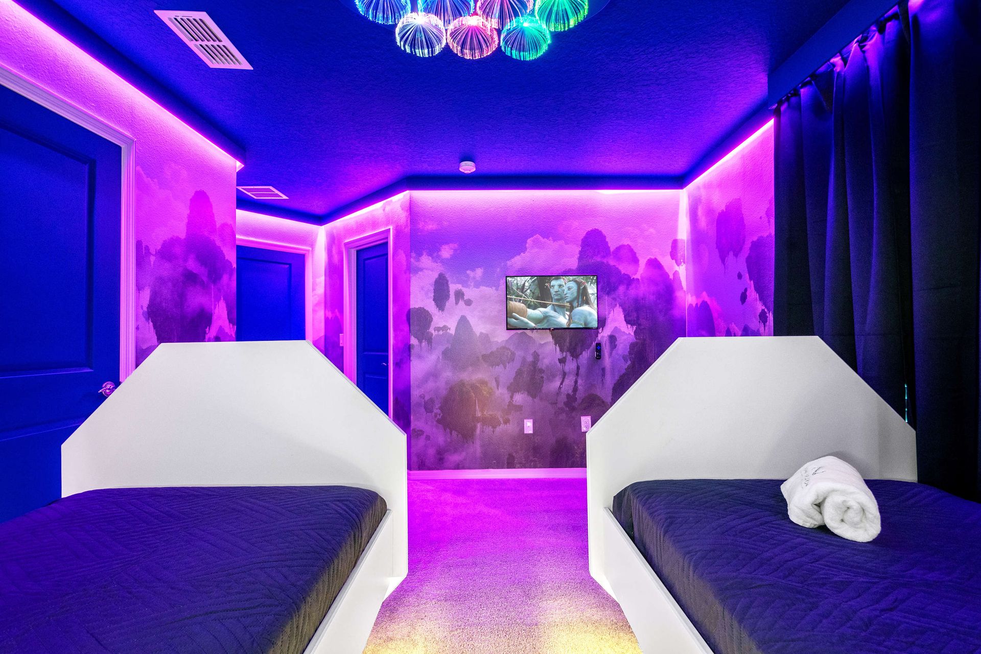 Glow into a galaxy of dreams in this neon-lit, sci-fi inspired twin bedroom.