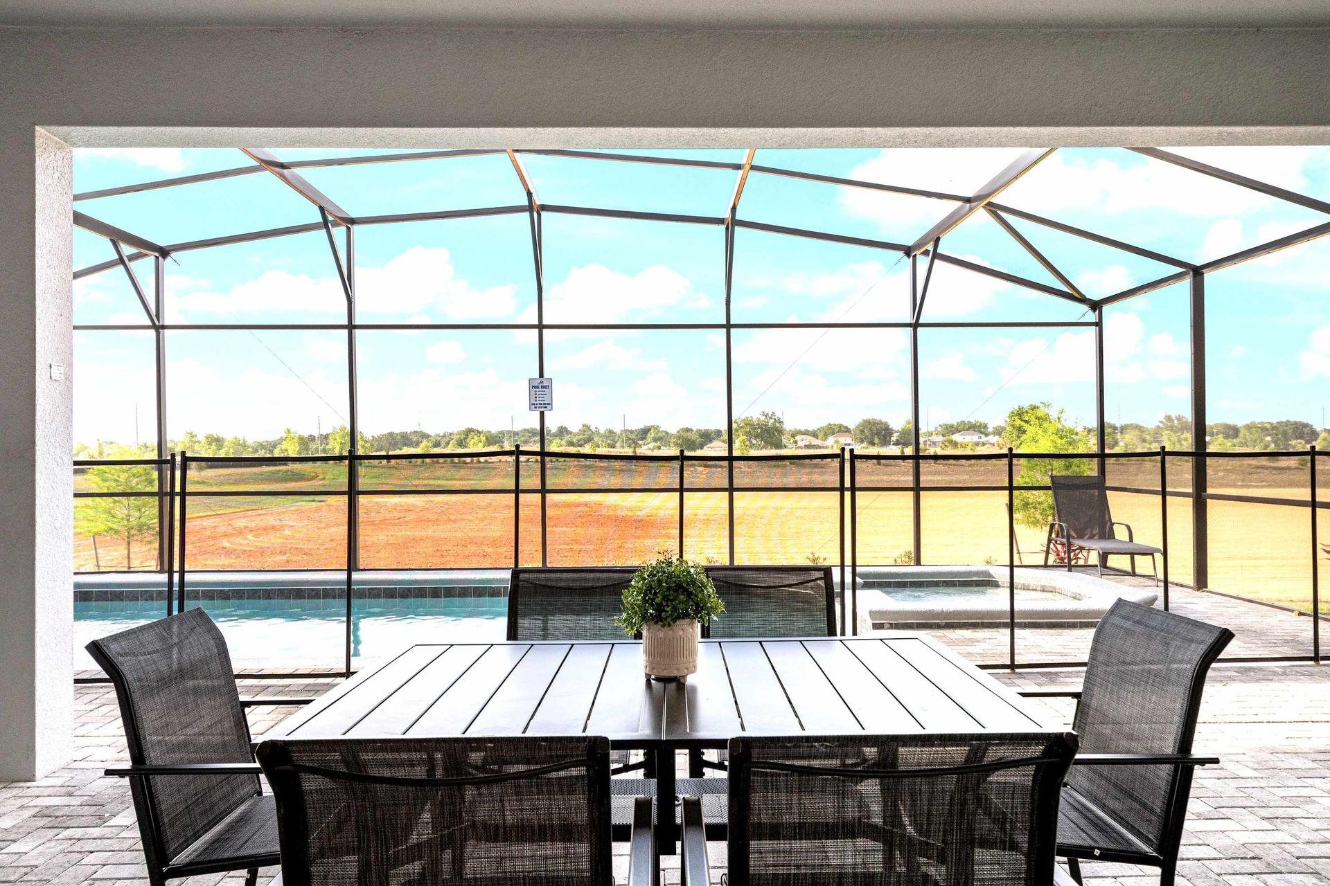 Enjoy outdoor dining with pool views and a screened lanai overlooking open fields.
