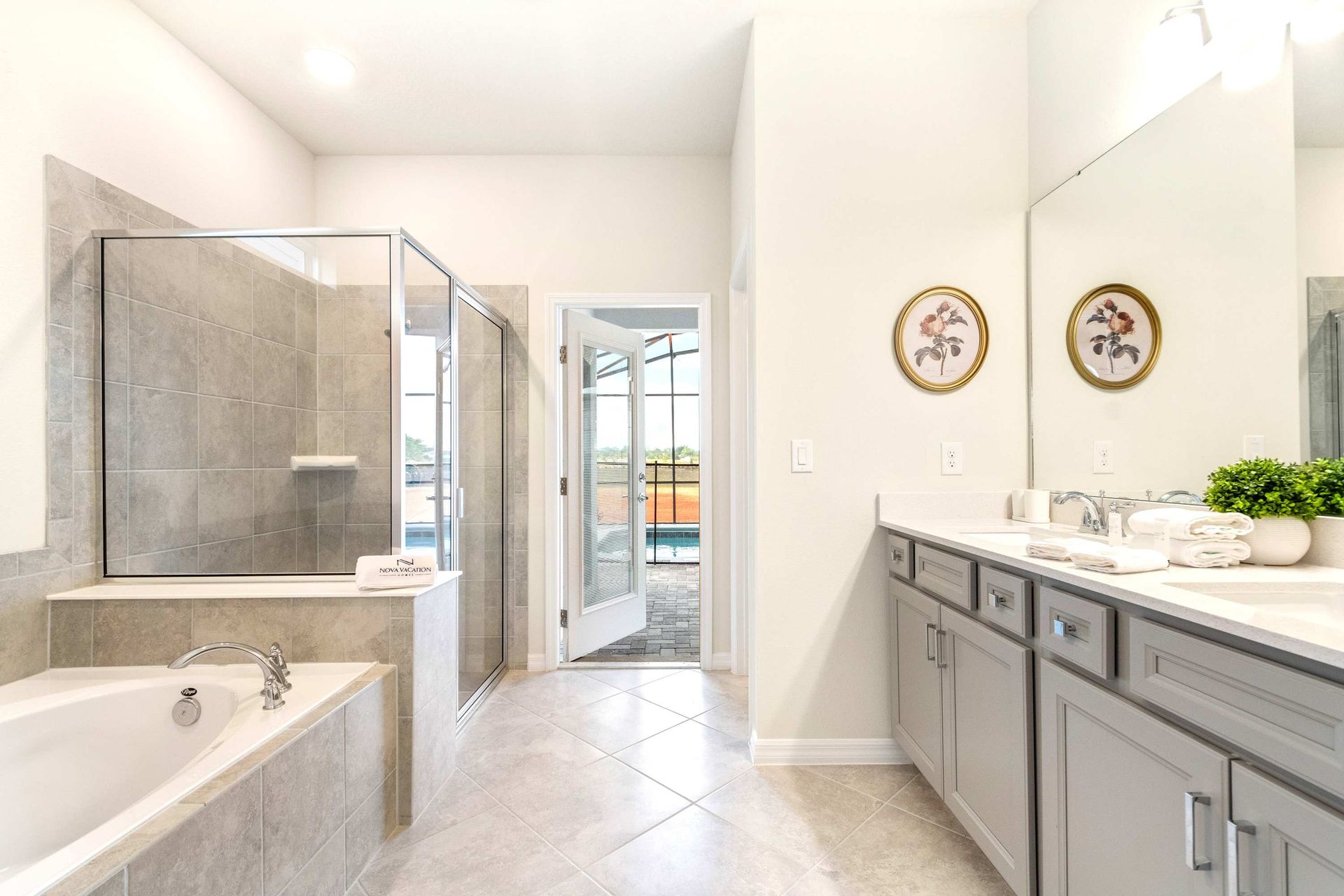 Spacious ensuite with soaking tub, dual sinks, and direct access to the pool.