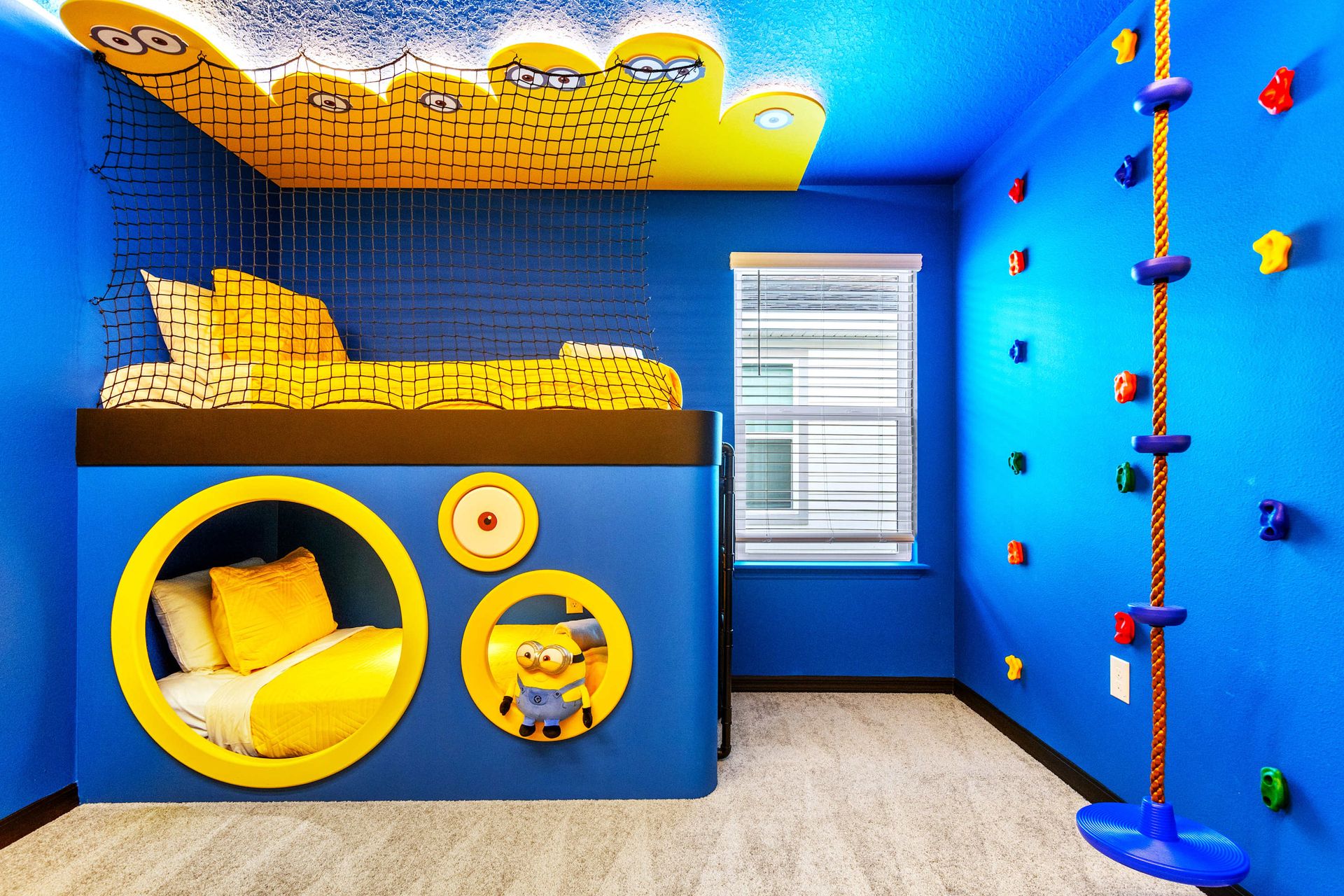 Fun-filled kids' room with themed bunk beds, climbing wall, and vibrant decor