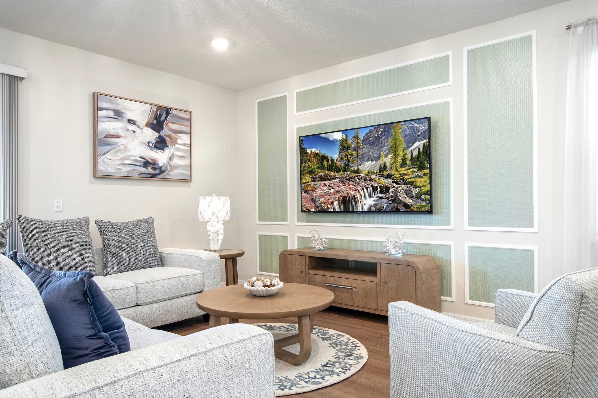 Cozy, stylish living room with smart TV, modern décor, and plush seating.
