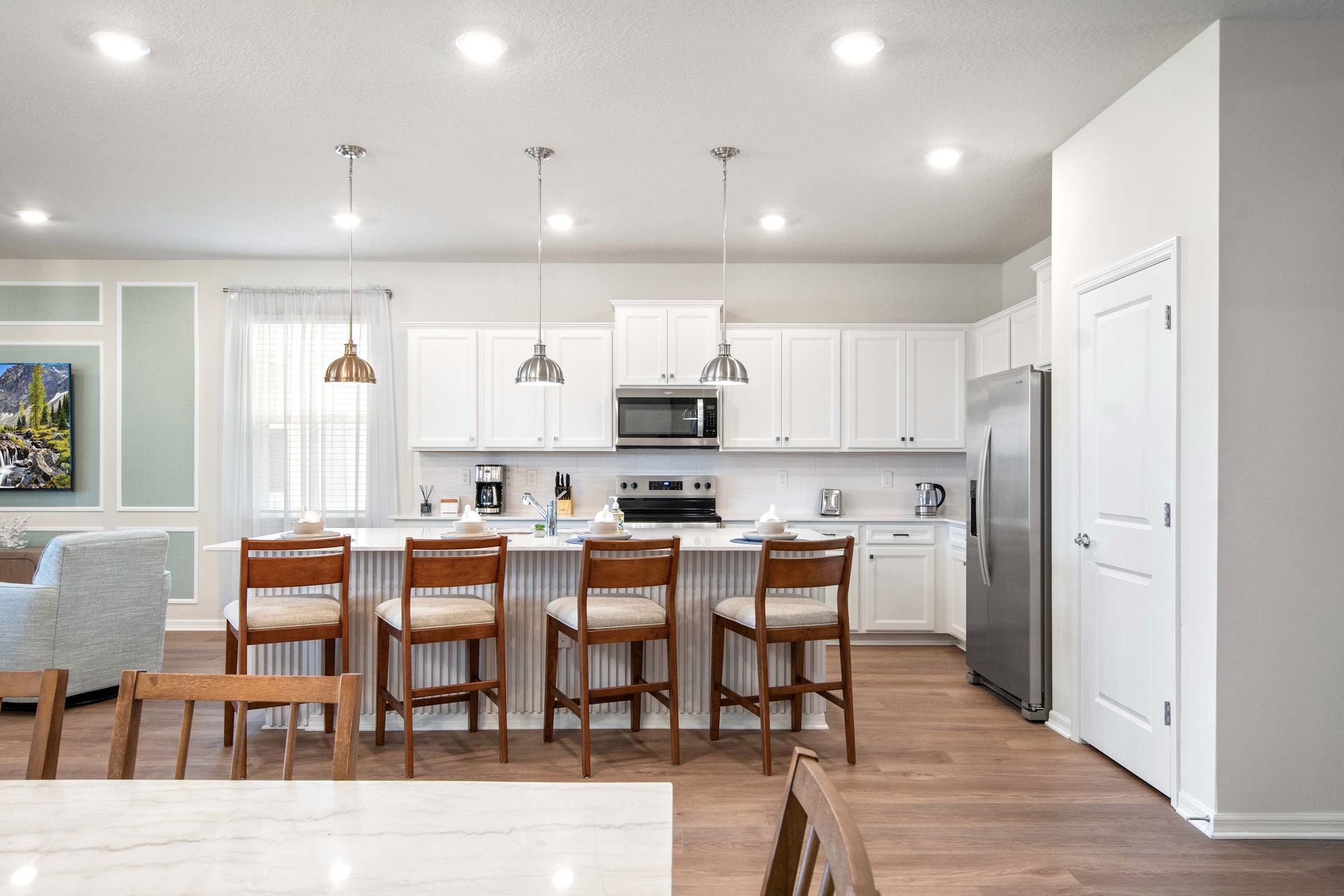 Bright, modern kitchen with stainless steel appliances and spacious breakfast bar.
