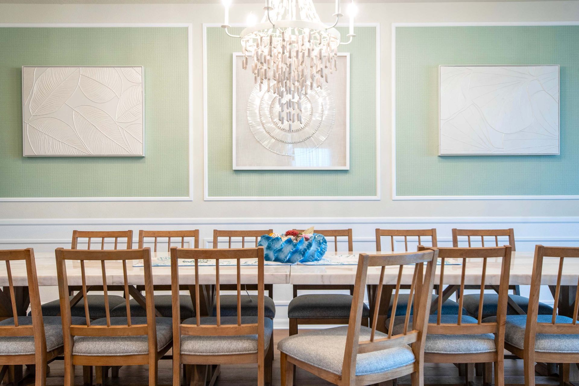 Chic dining room with elegant chandelier, seating for 12, and stylish accents.
