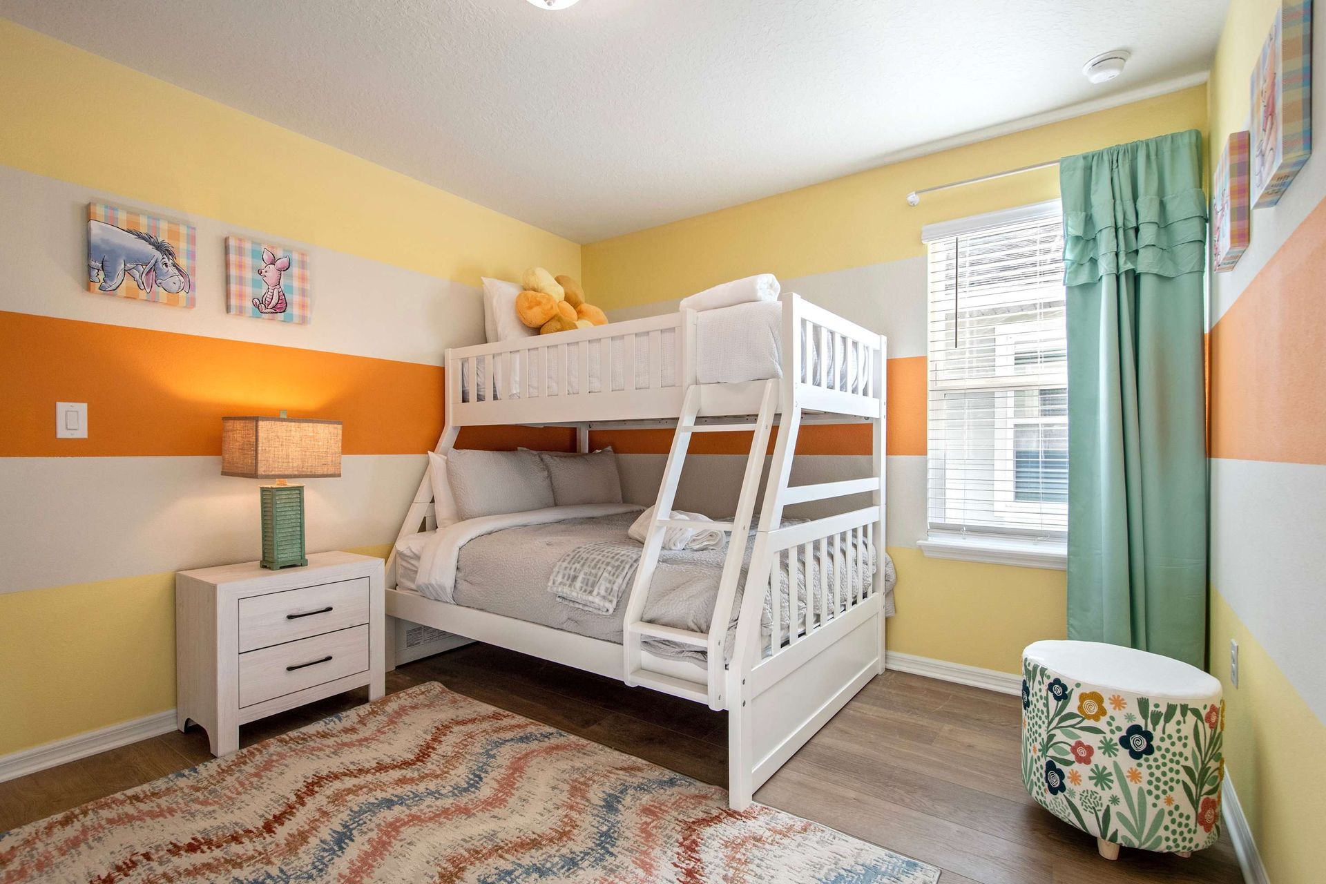 Cheerful bunk room with twin-over-full bed, fun colors, and cozy kid-friendly vibe.
