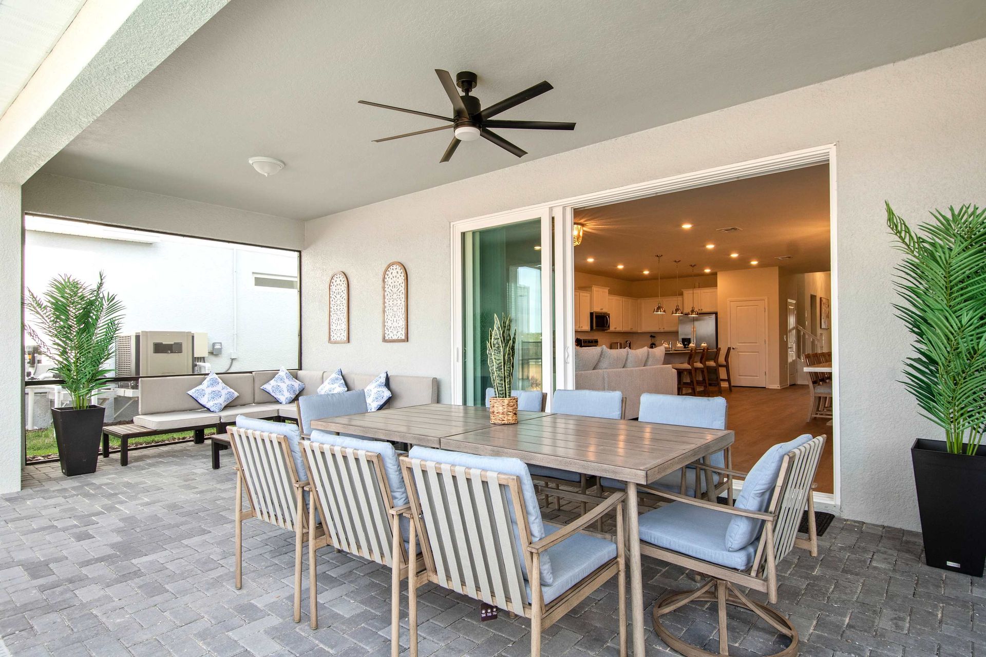 Spacious covered patio with dining area, lounge seating, and indoor-outdoor flow.
