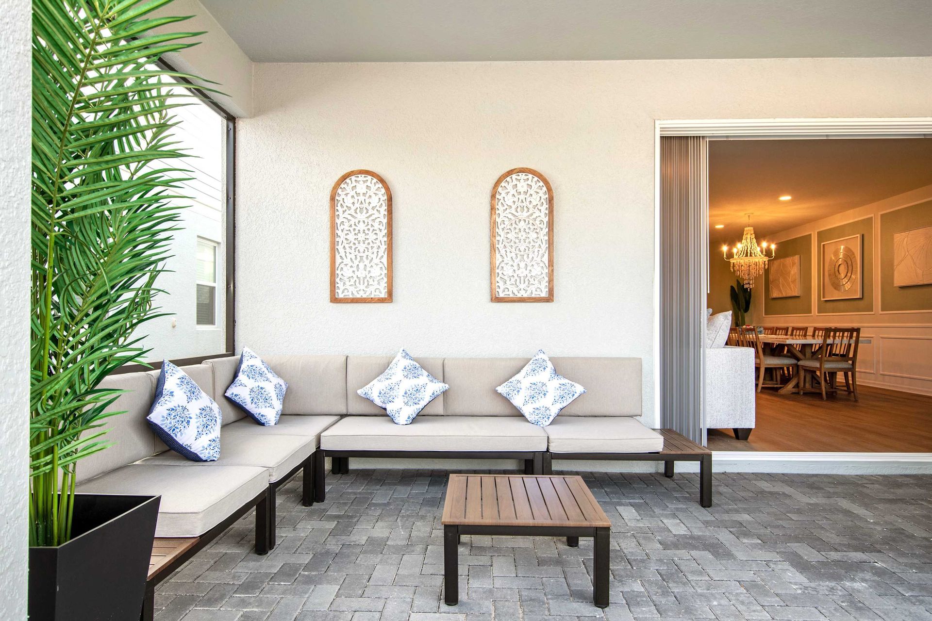 Cozy outdoor lounge with cushioned seating, stylish decor, and indoor-outdoor flow.
