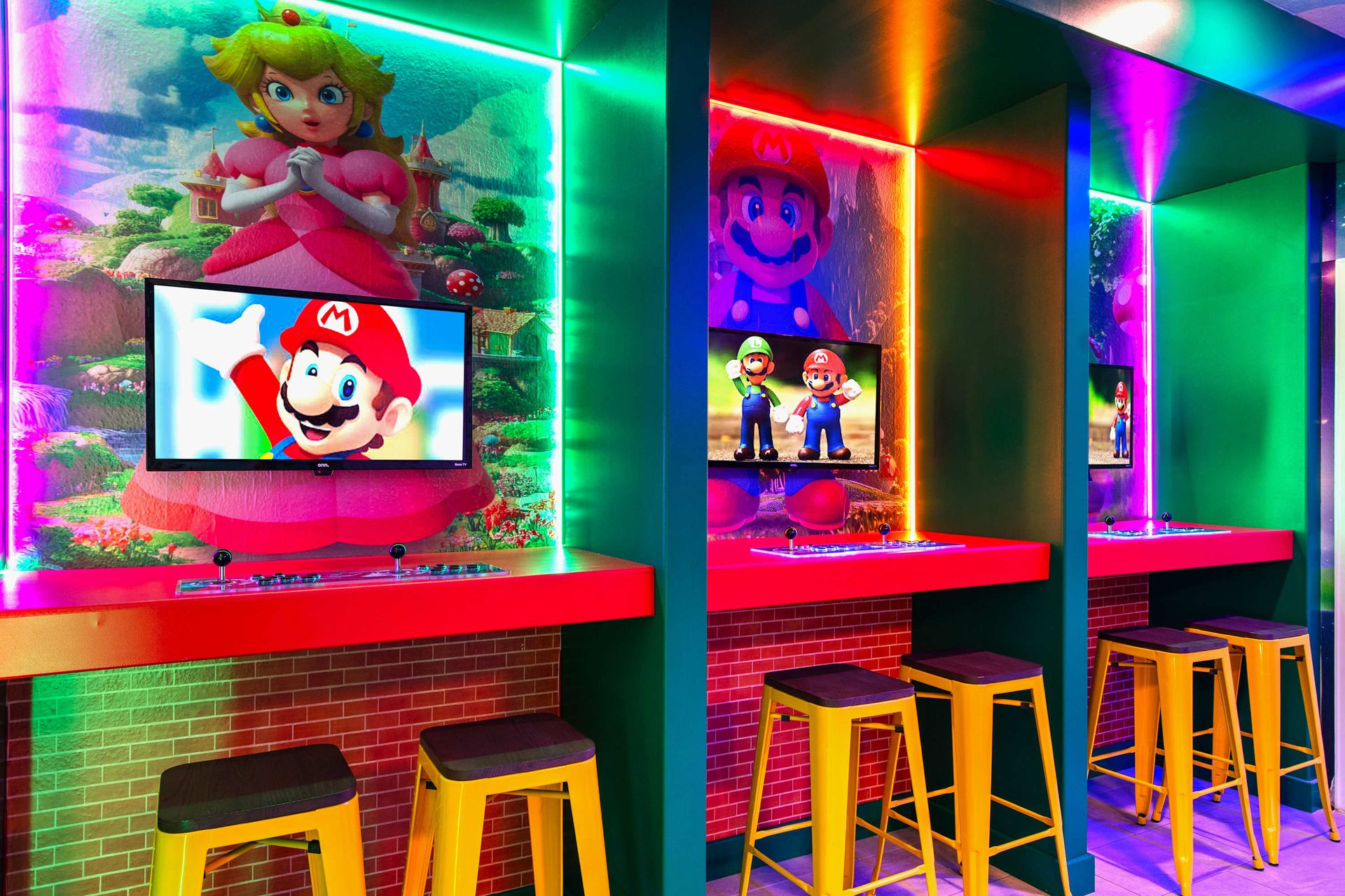 Super Mario gaming lounge with vibrant neon lights, wall art, and console setups!
