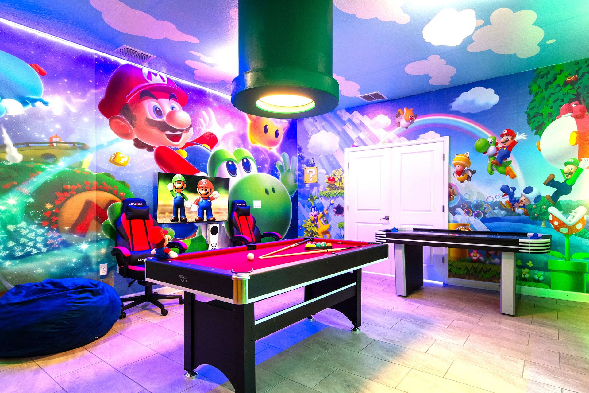 Immersive Super Mario game room with pool, air hockey, and vibrant wall art!
