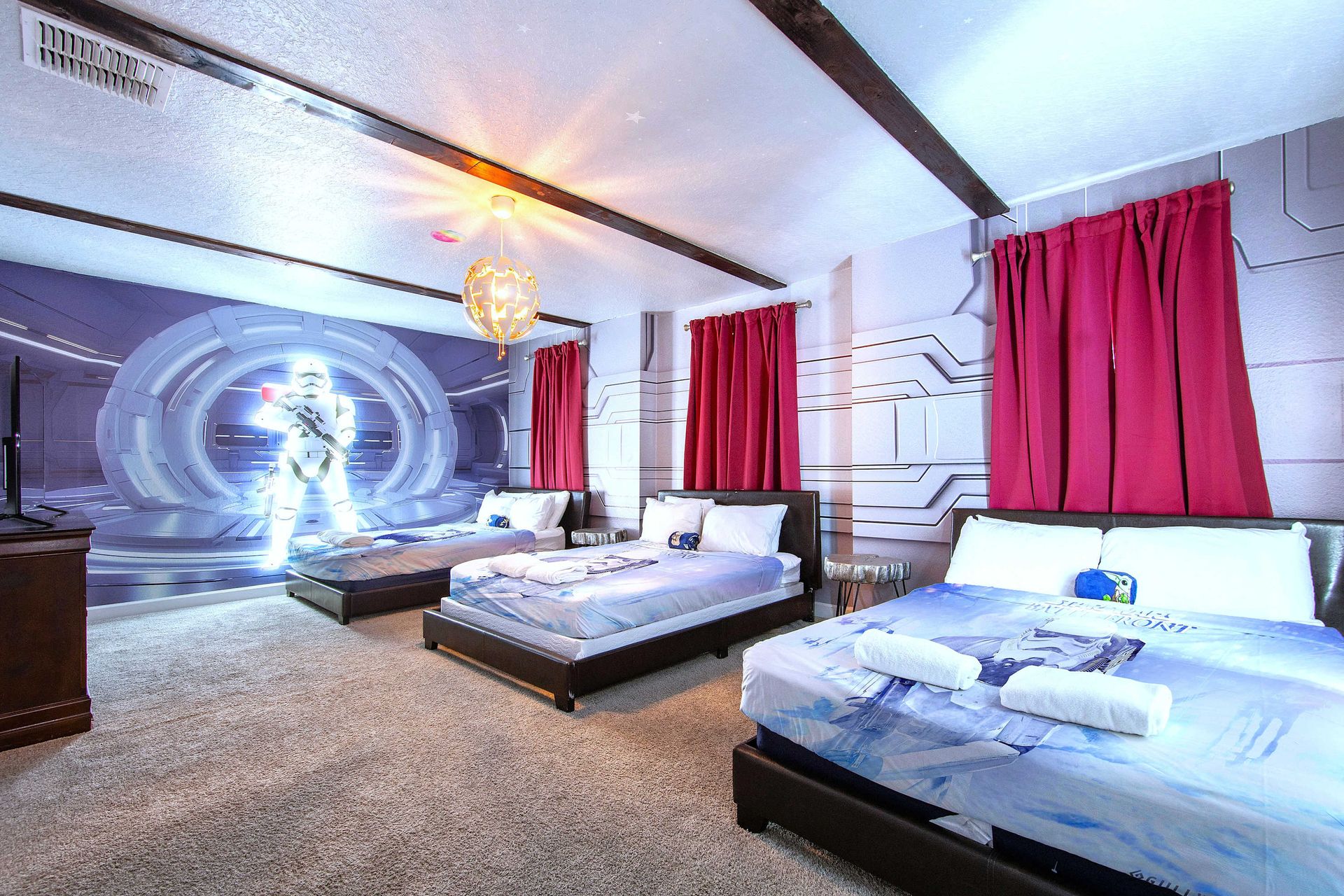 Spacious sci-fi room with space-themed beds, wall art, and room for the crew.
