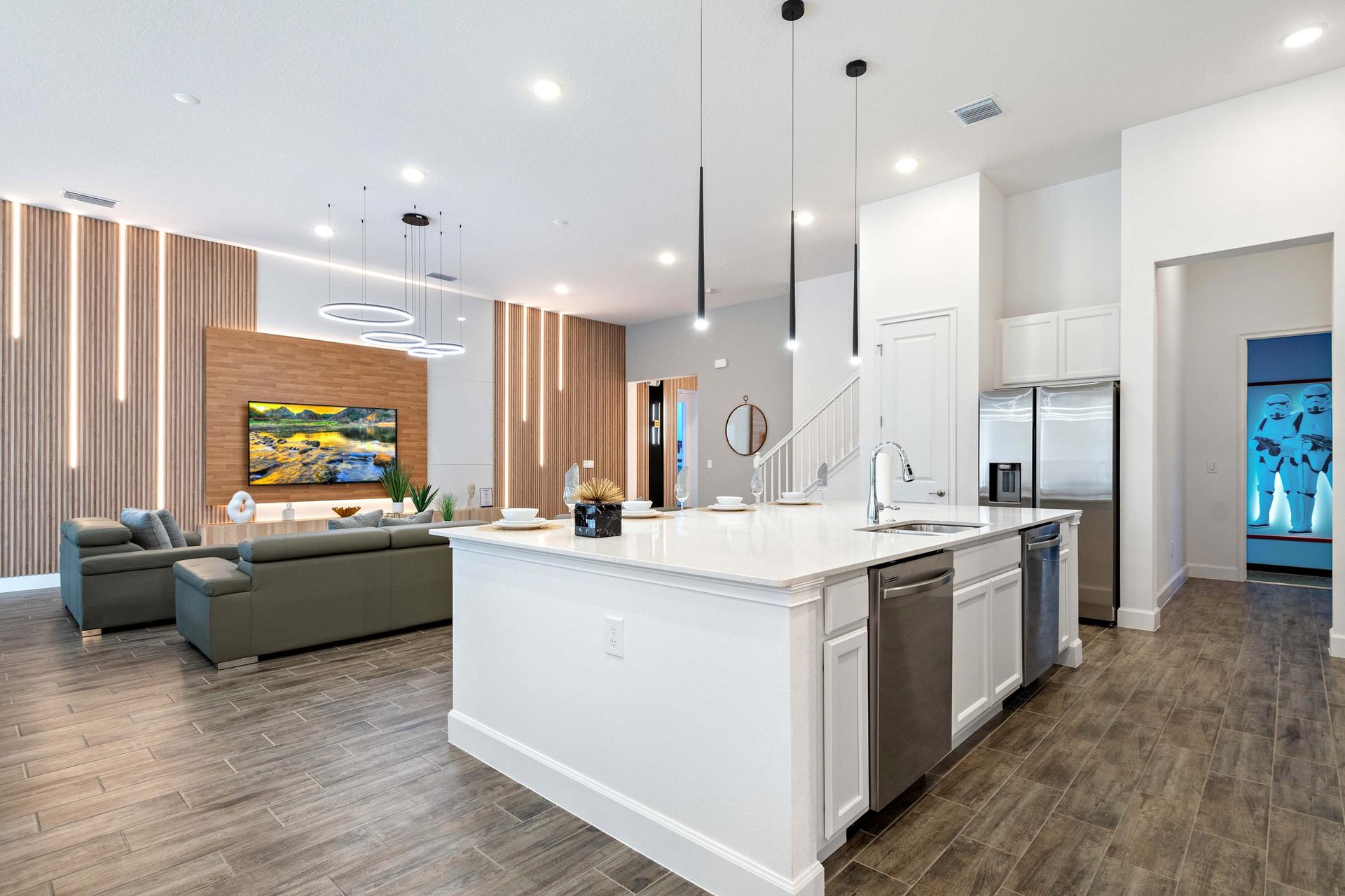 Stylish open kitchen with island seating, modern lighting, and seamless flow

