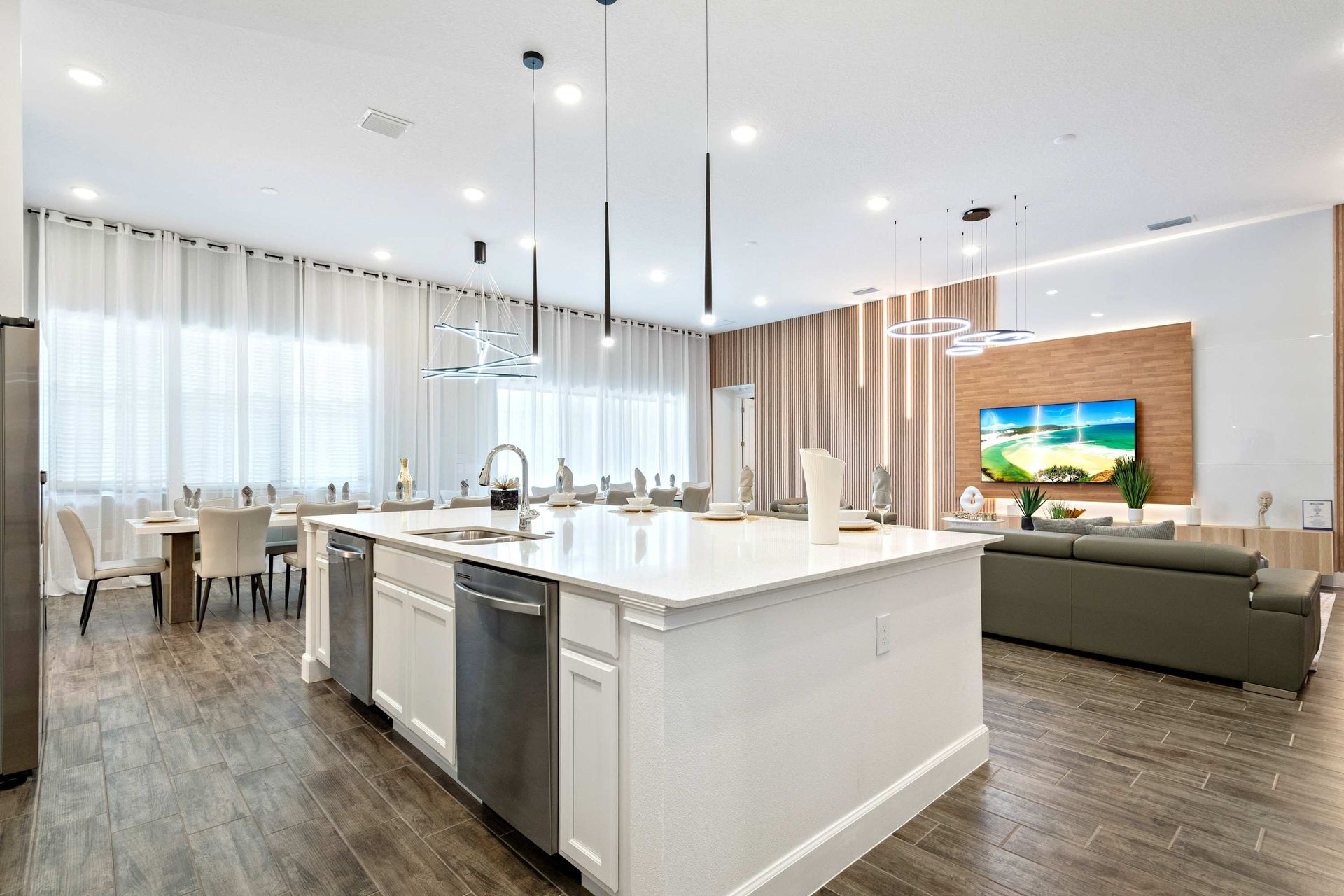 Stylish open kitchen with island seating, modern lighting, and seamless flow

