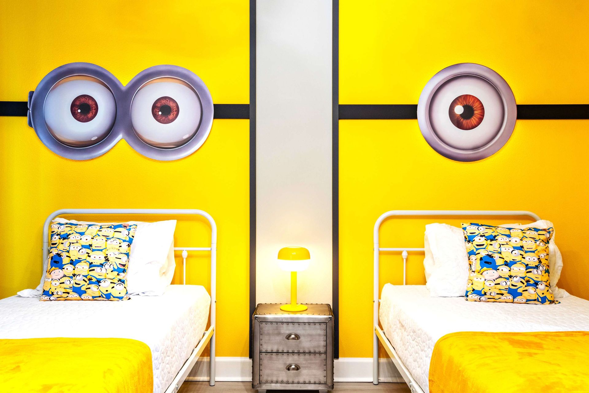 Bright and whimsical twin room with fun yellow theme and playful character decor
