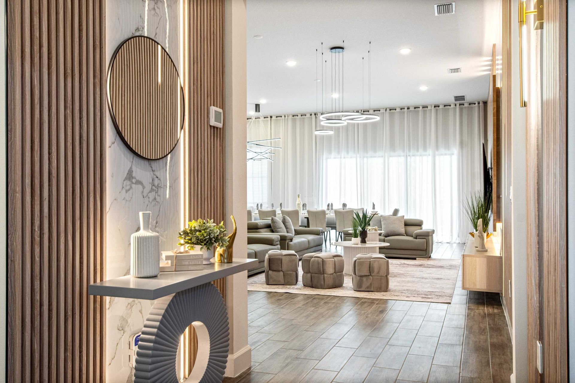 Bright, elegant entryway leads to spacious living area with stylish, modern decor.
