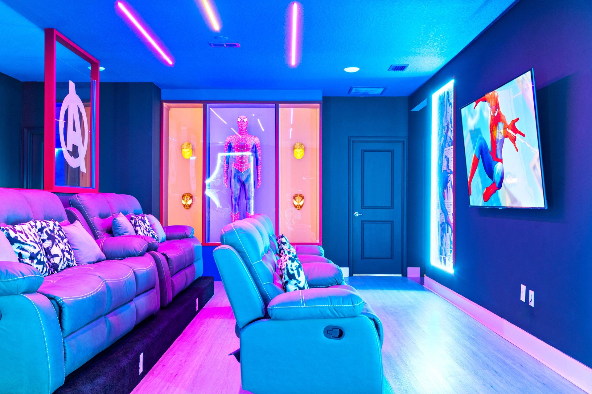 Epic superhero-themed theater with neon lights, recliners, and immersive sound
