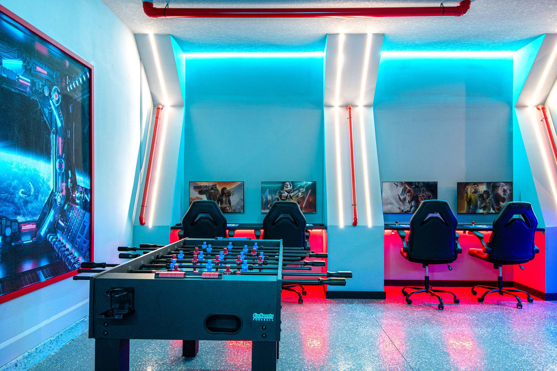 Futuristic game zone with foosball, gaming stations, and bold neon lighting

