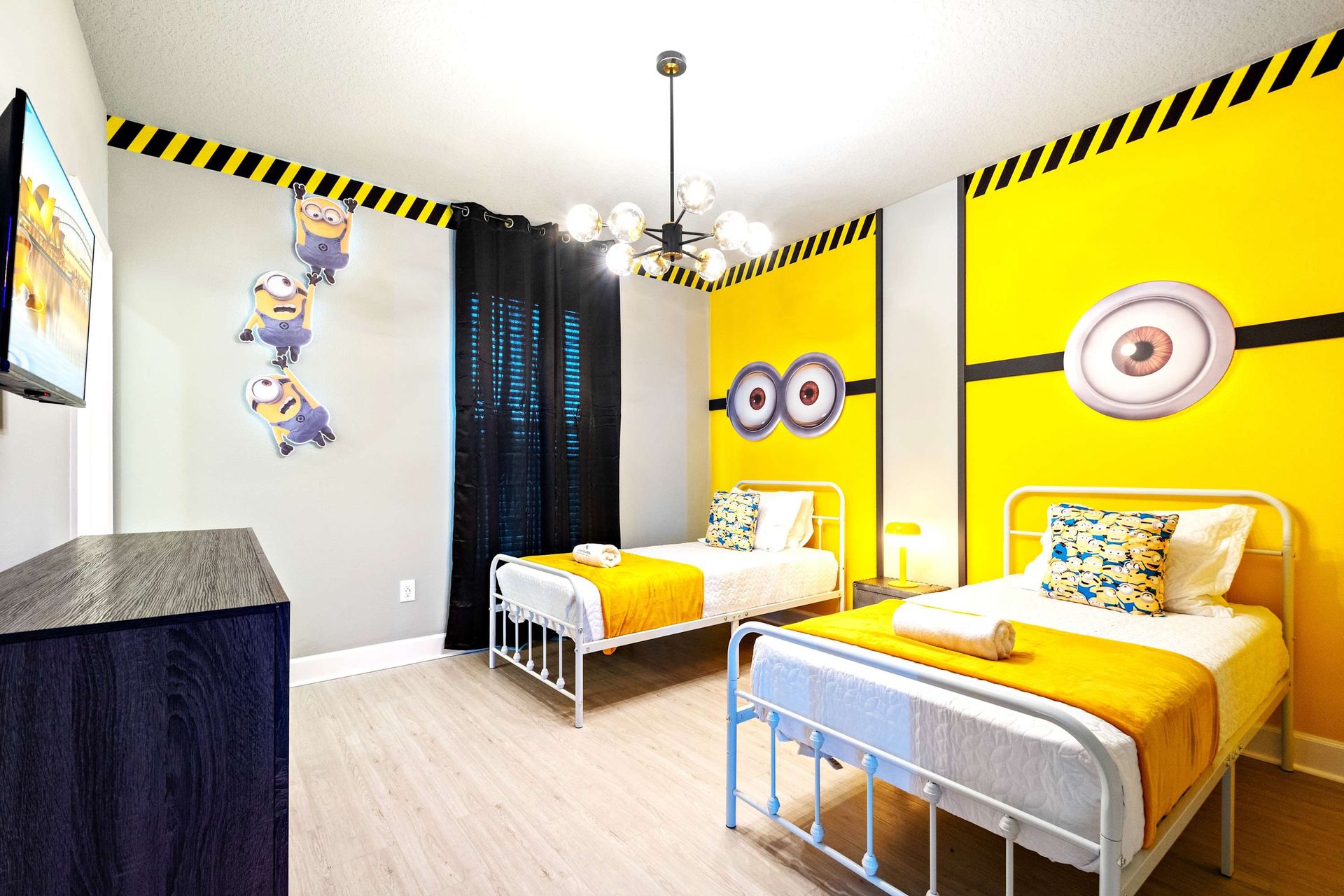Bright and whimsical twin room with fun yellow theme and playful character decor
