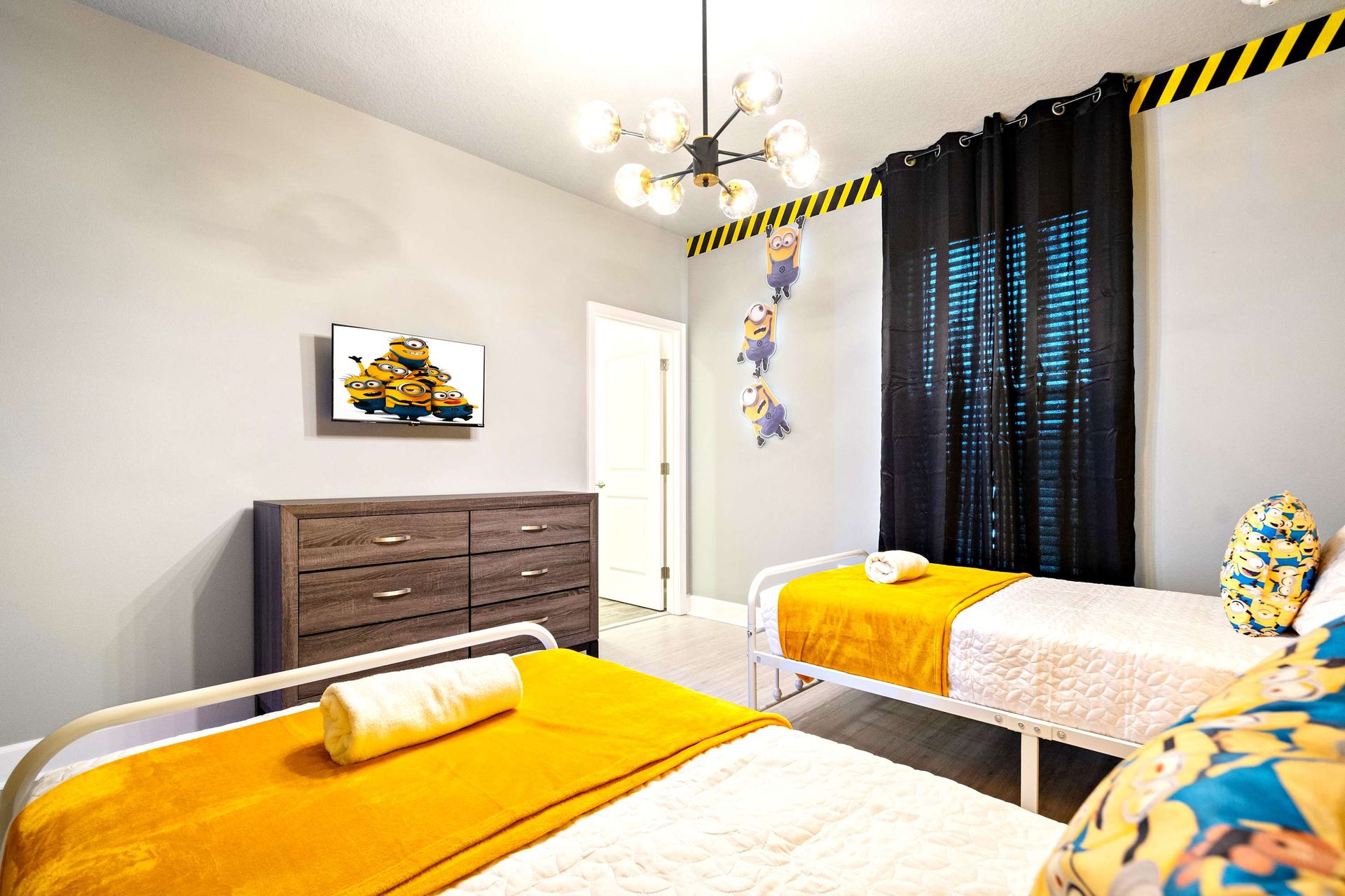 Bright and whimsical twin room with fun yellow theme and playful character decor
