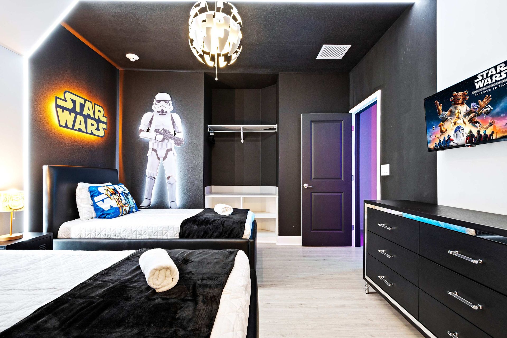 Galactic twin bedroom with glowing Star Wars theme and cozy space adventure vibes
